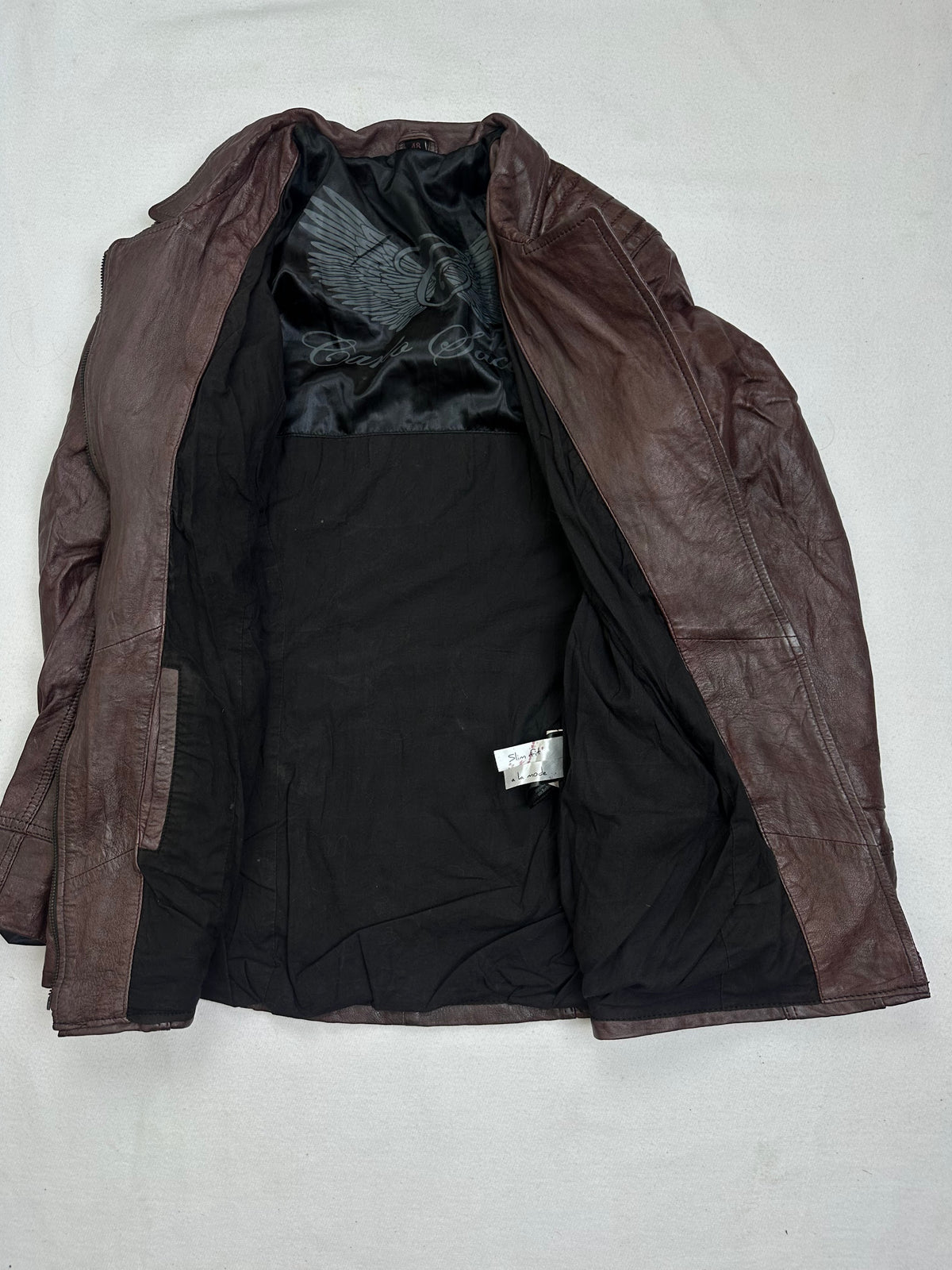 The size M burgundy leather biker jacket opened to show the lining