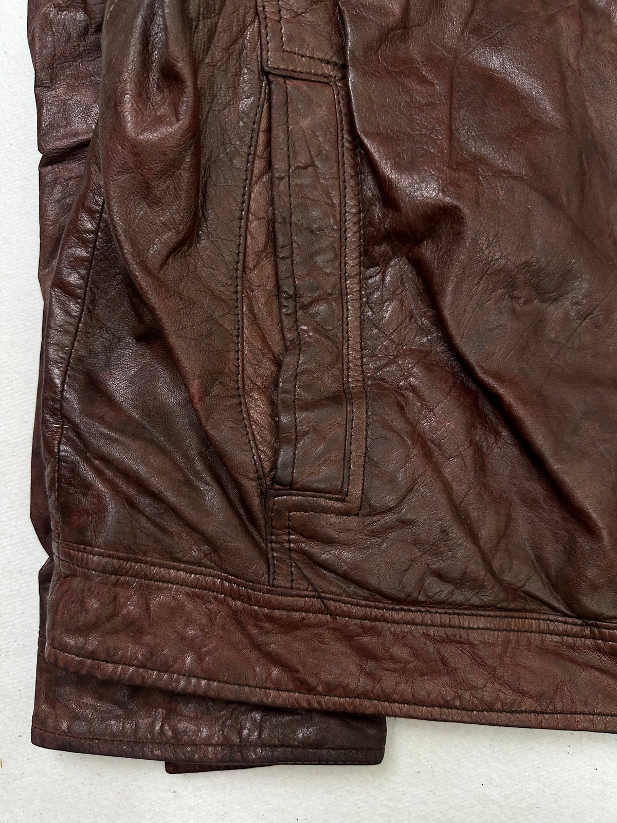 Close detail of the pockets and cuff on the size L burgundy leather vintage jacket