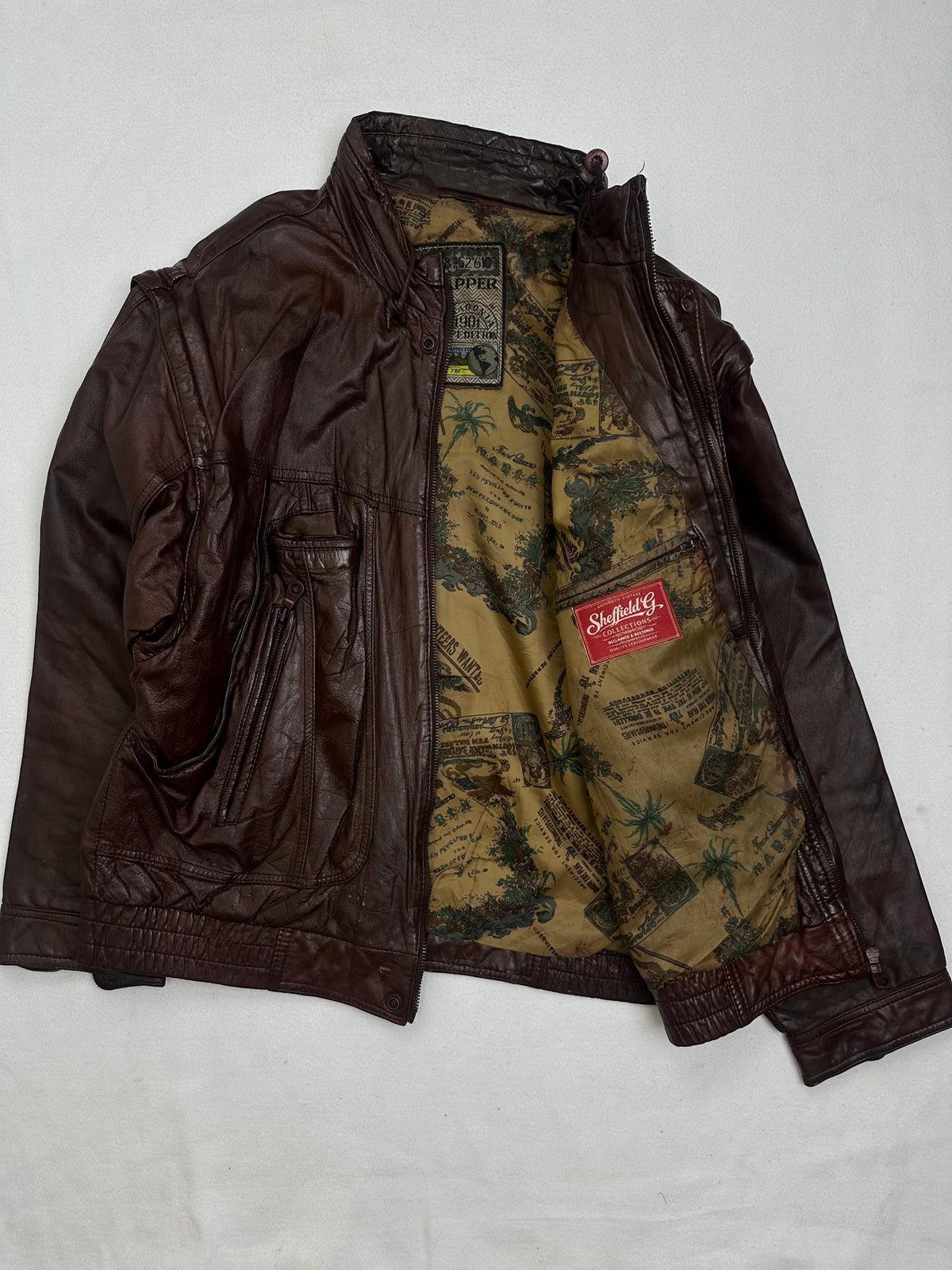 The size L burgundy leather flight jacket opened to show the lining