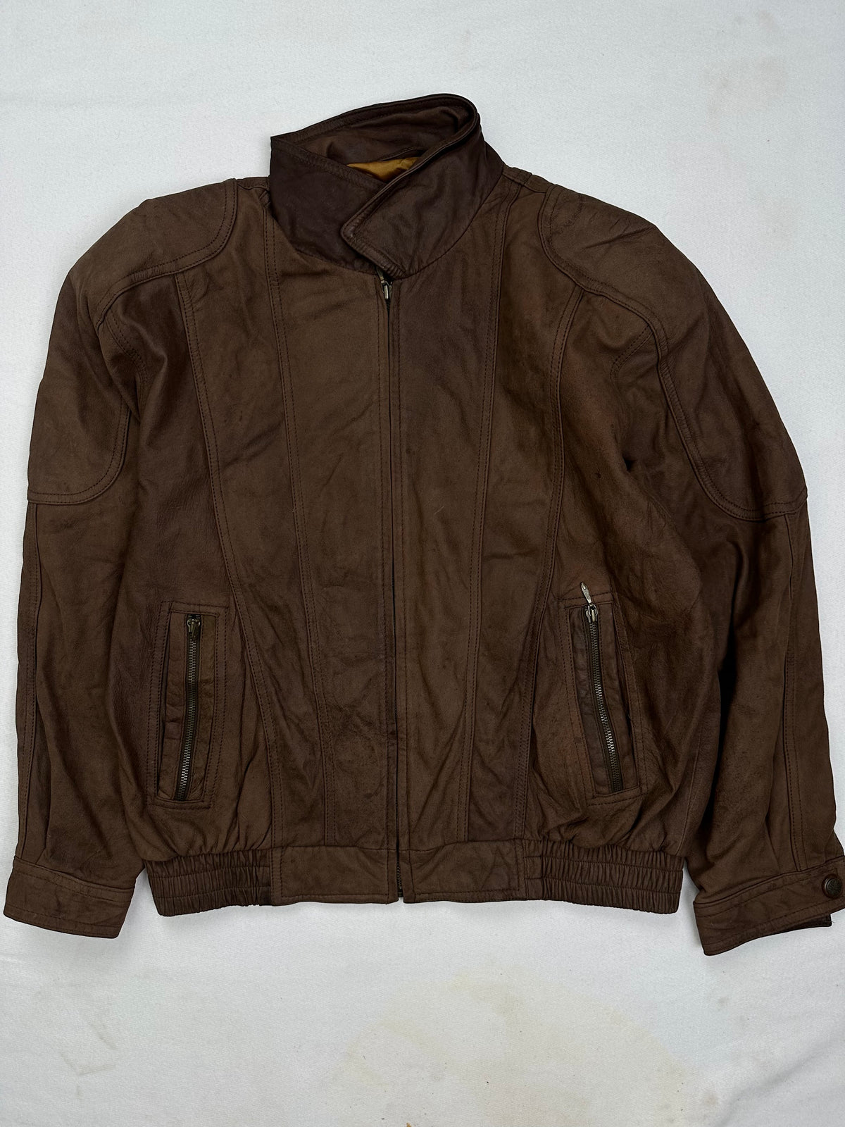 Front of the size L brown leather flight jacket, laid flat and unedited