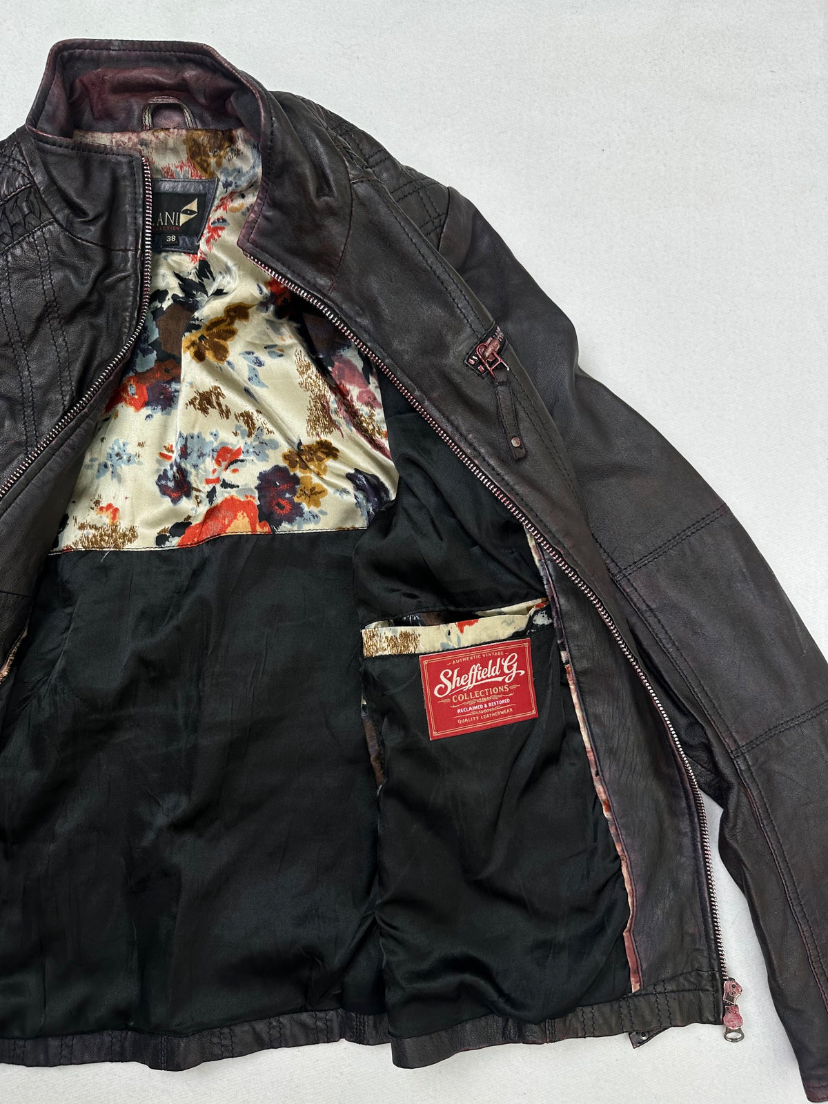 The size S burgundy leather cafe racer jacket opened to show the lining