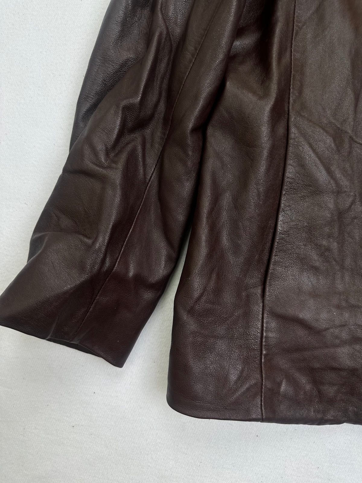Close detail of the pockets and cuff on the size L burgundy leather vintage jacket