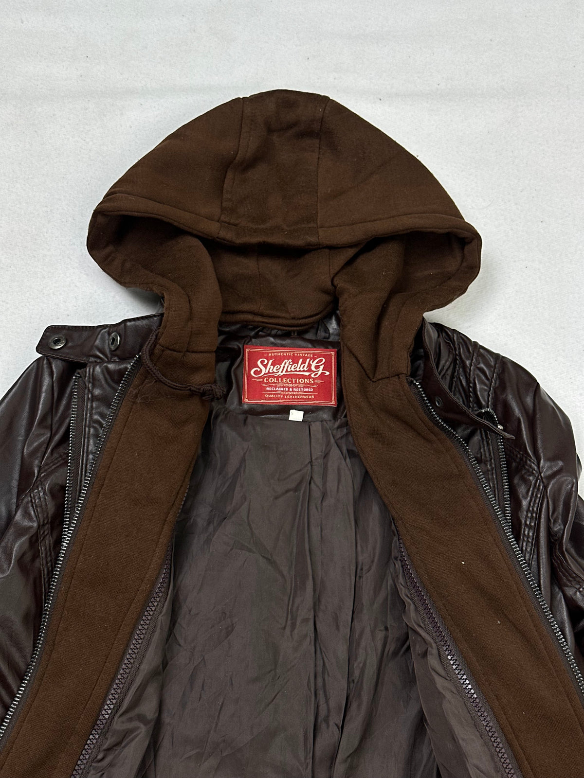 The size M brown leather hooded jacket opened to show the lining