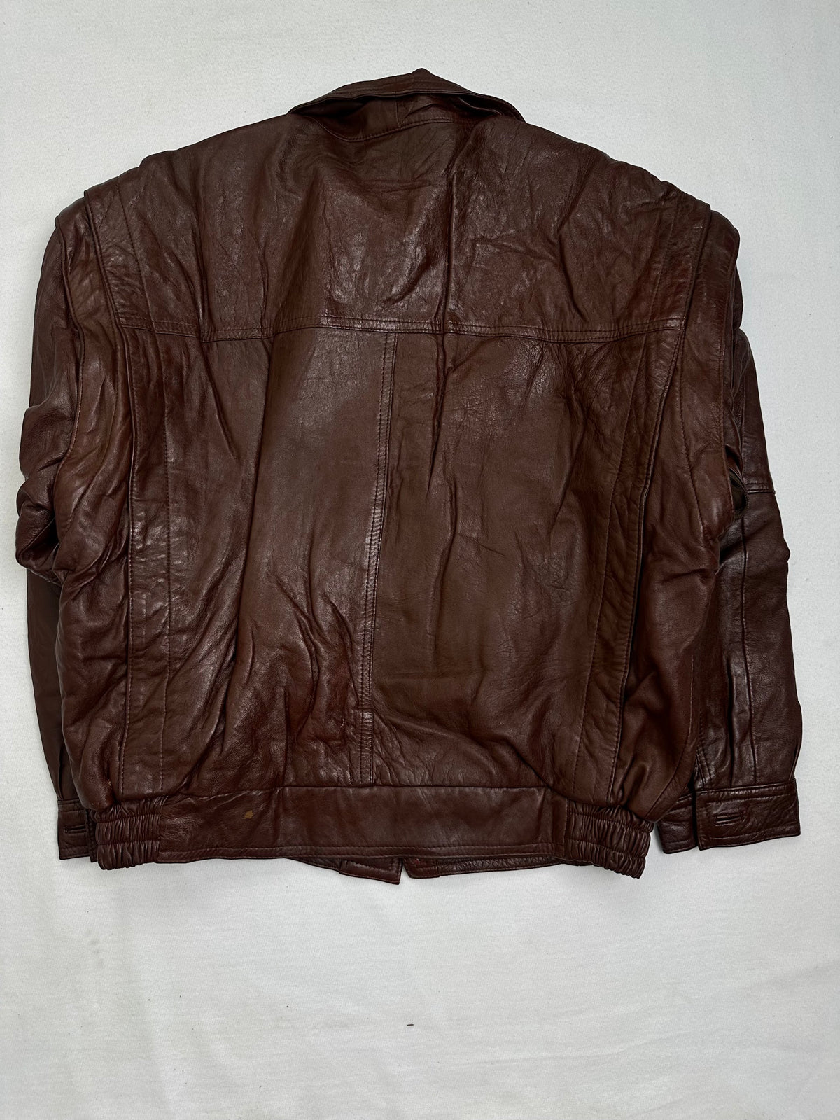 Back of the size S burgundy leather harrington jacket, laid flat
