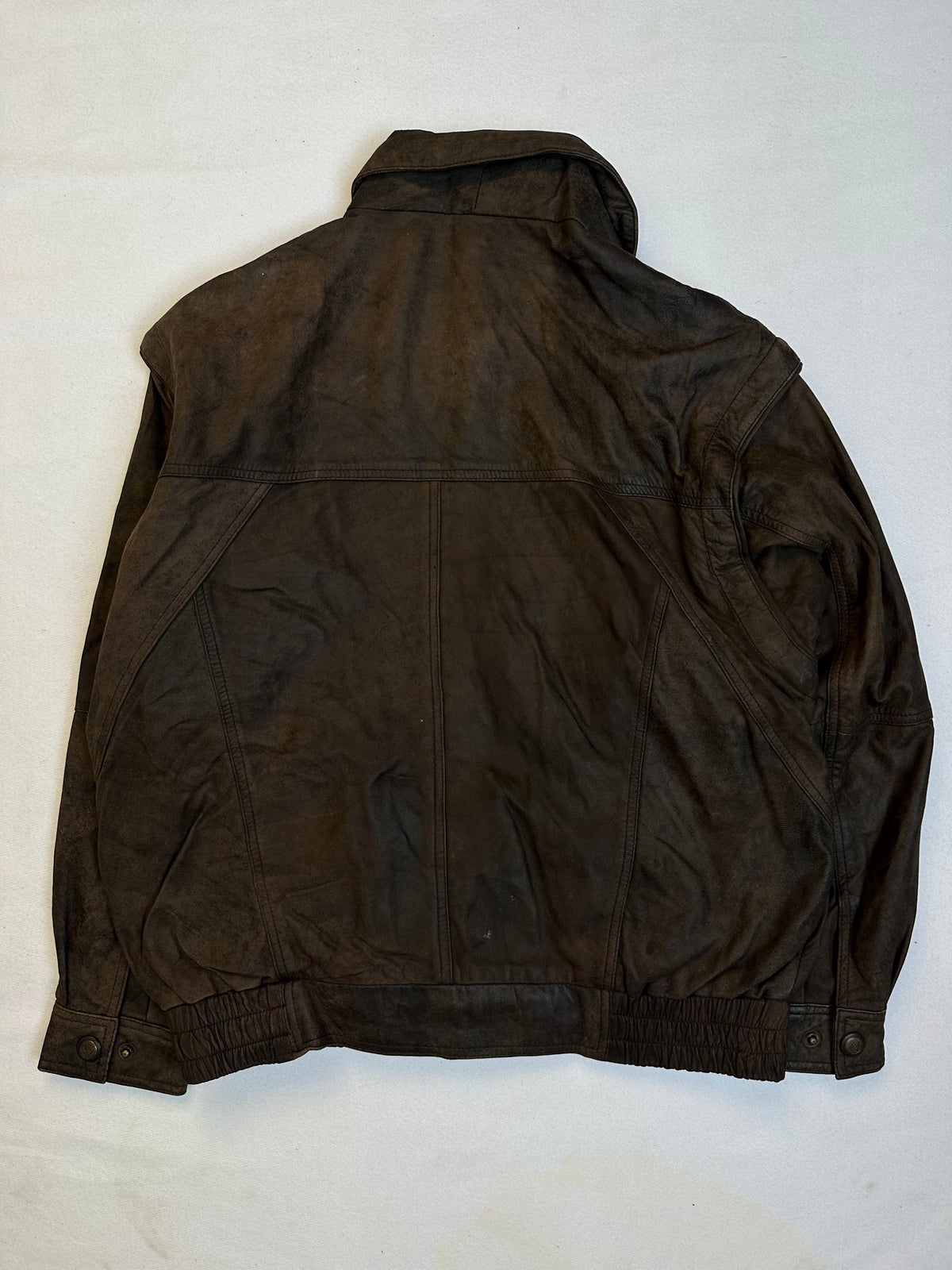 Back of the size L brown leather flight jacket, laid flat
