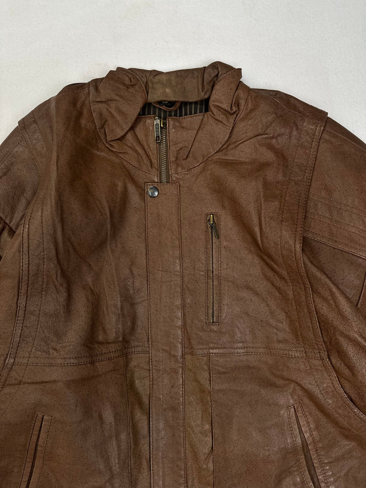Vertical zip chest pocket above a slanted welt hand pocket