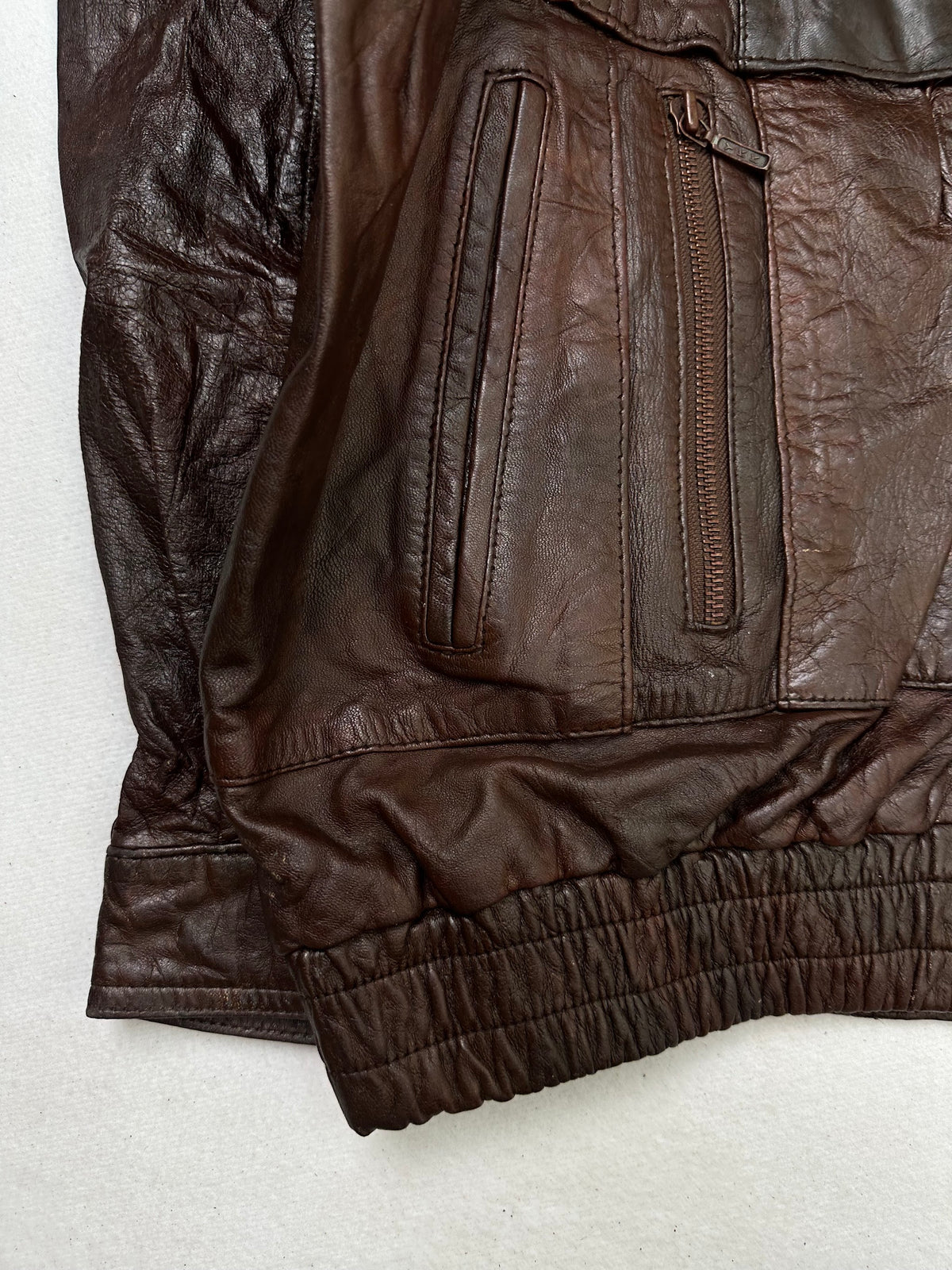 Close detail of the pockets and cuff on the size XL burgundy leather flight jacket