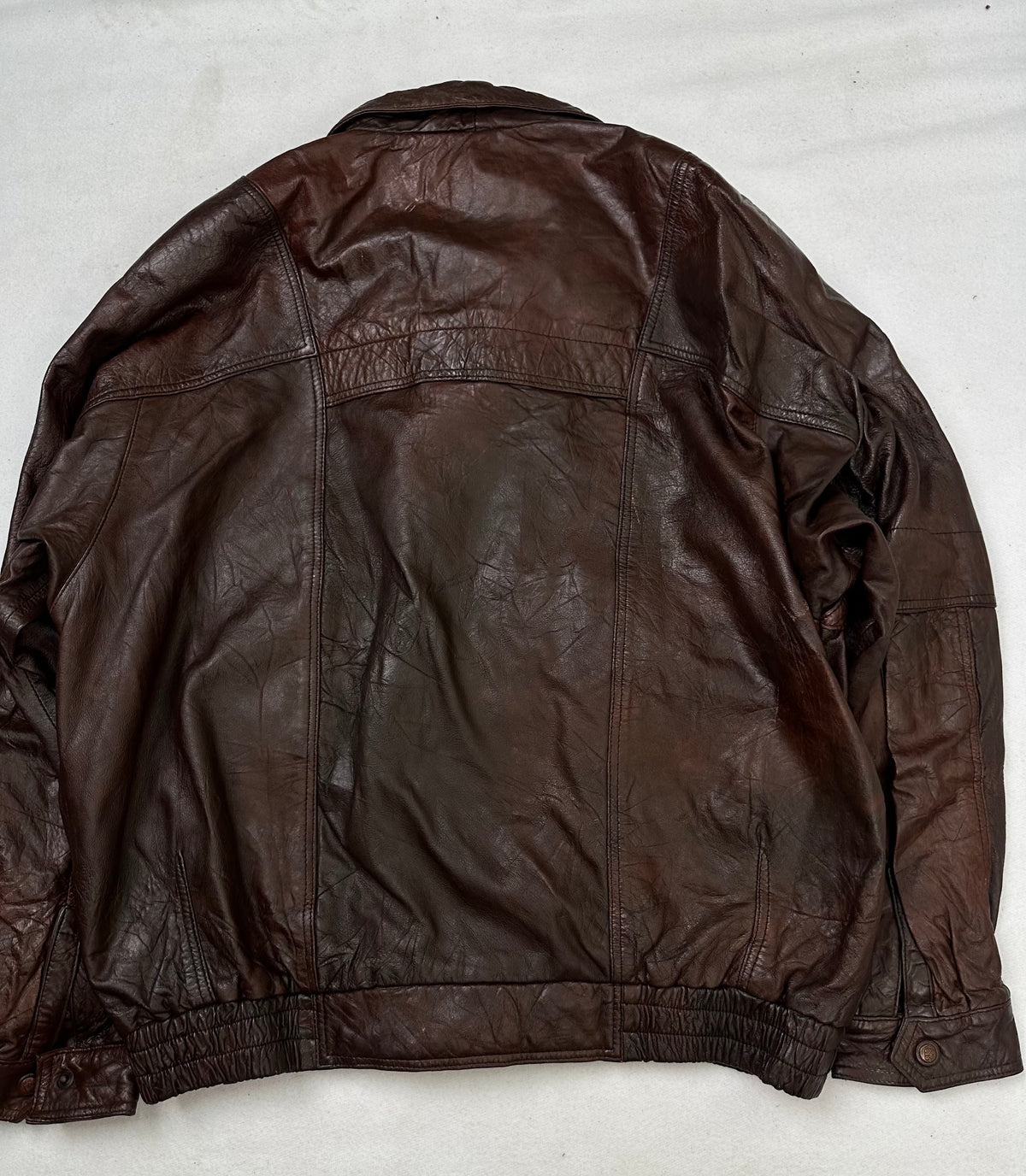 Back of the size XL burgundy leather flight jacket, laid flat