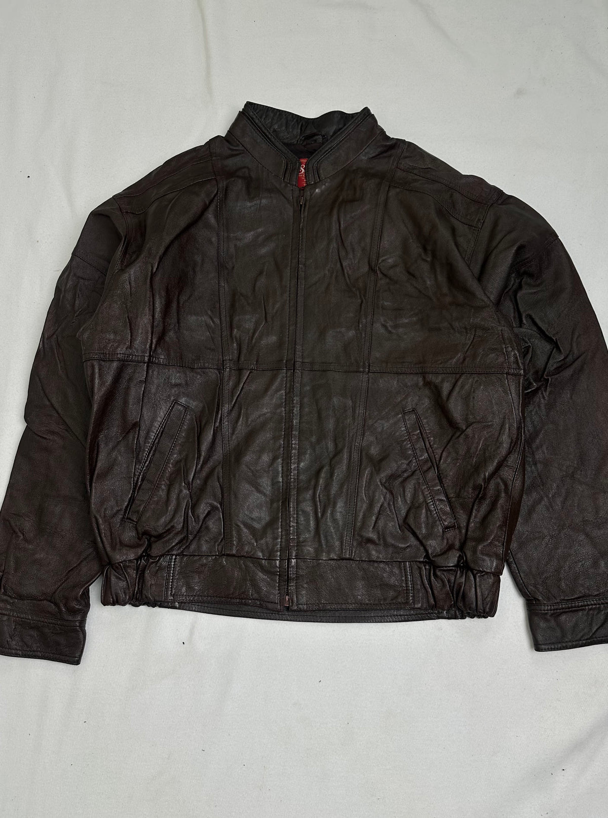 Back of the size L brown vintage jacket laid flat