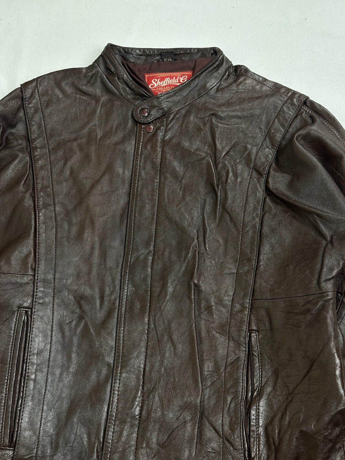Vertical welt pocket set into the waist beside the shirred band