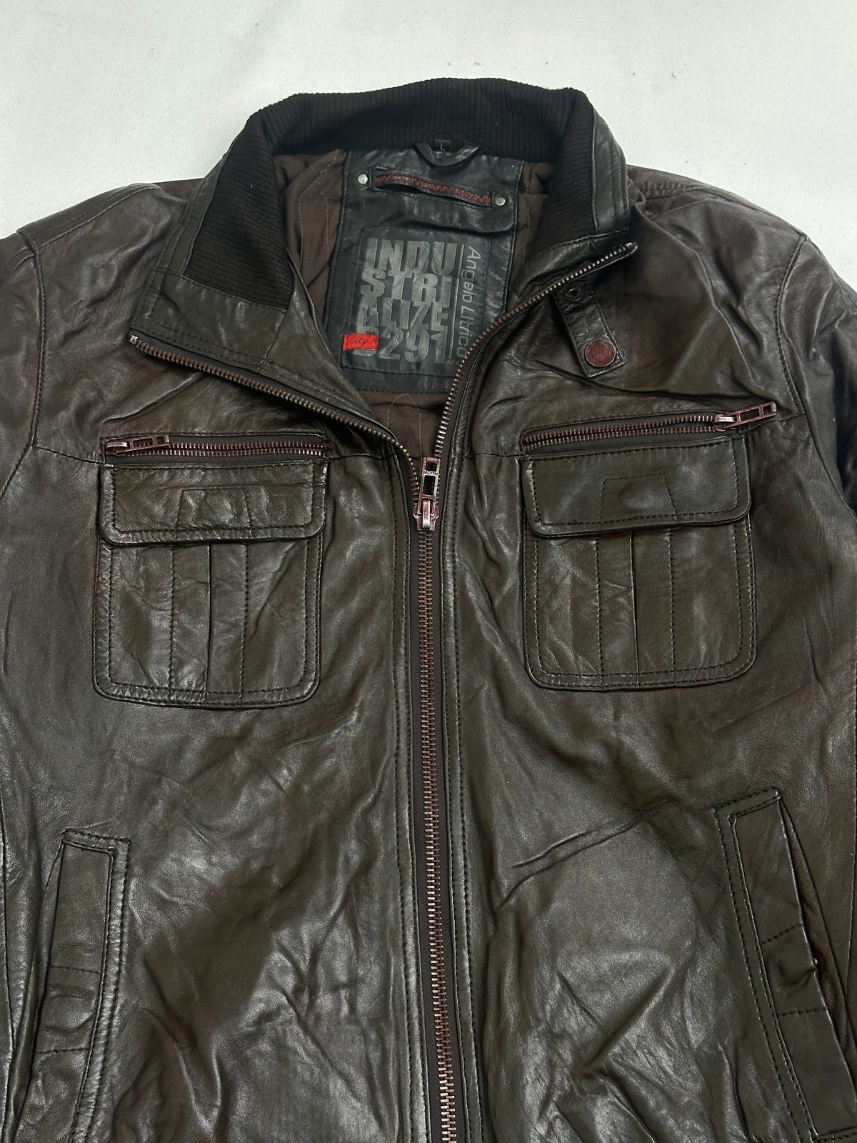 Deep brown quilted lining shown with the bomber held open