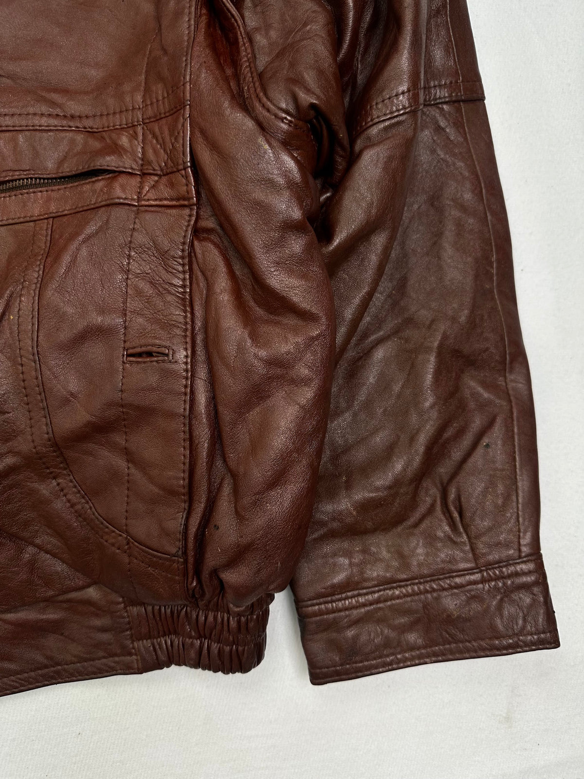 Right side pocket and hem of the size S burgundy leather harrington jacket