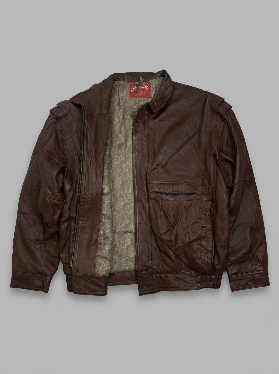 Burgundy leather harrington jacket laid flat and open, showing the pale sage-green paisley jacquard lining