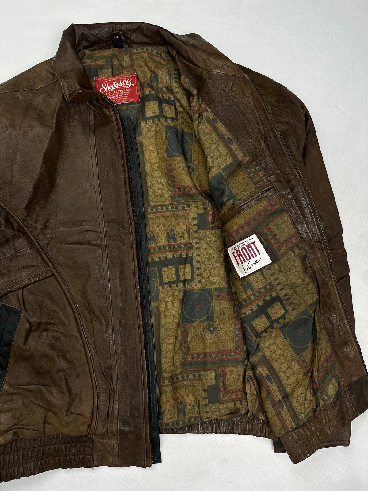Patterned olive and khaki lining shown with the jacket open