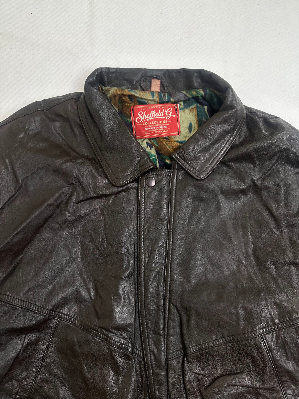 Slanted zip hand pocket under the chest yoke seam on the brown jacket