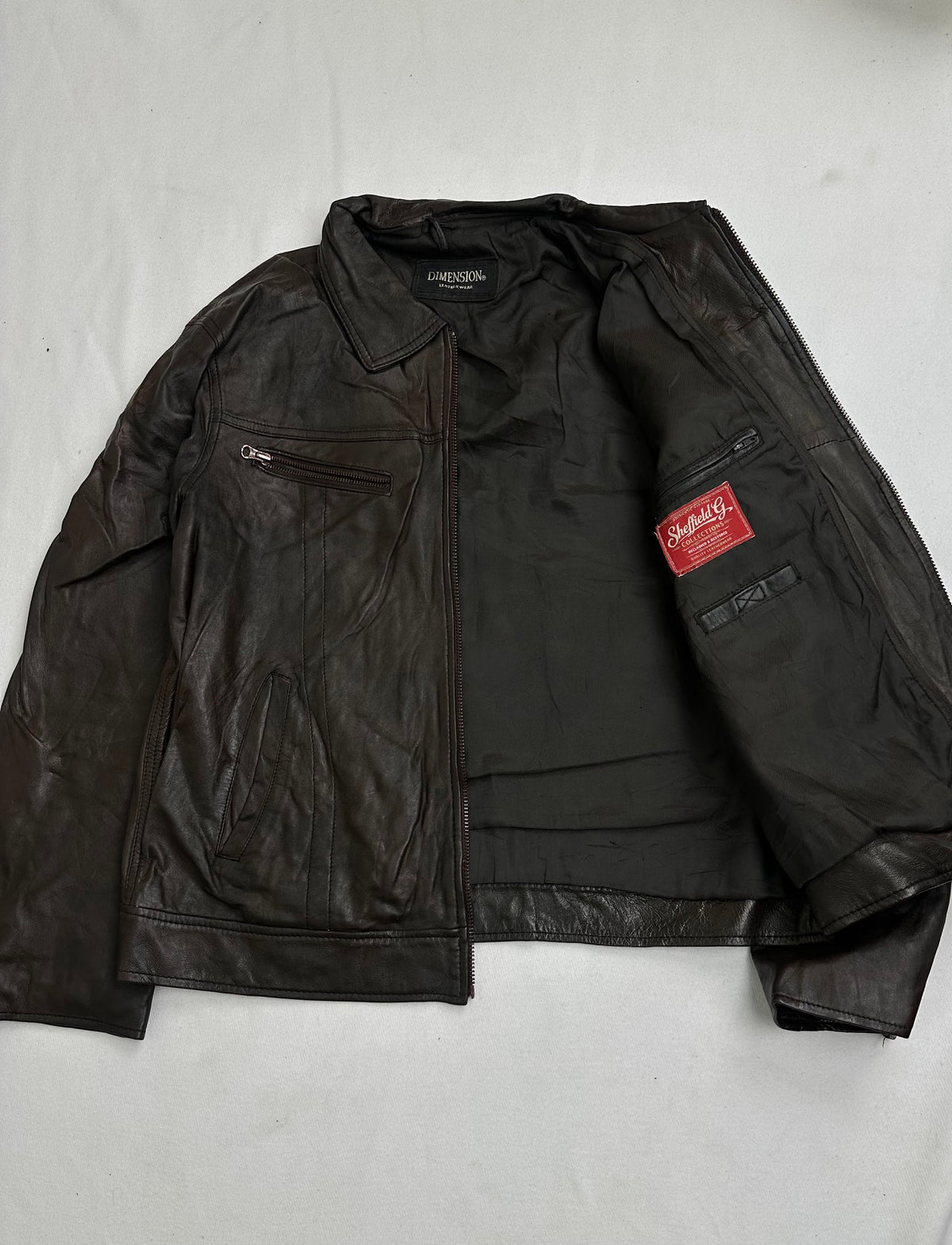 Zip pocket in the chest yoke seam above a slanted welt pocket