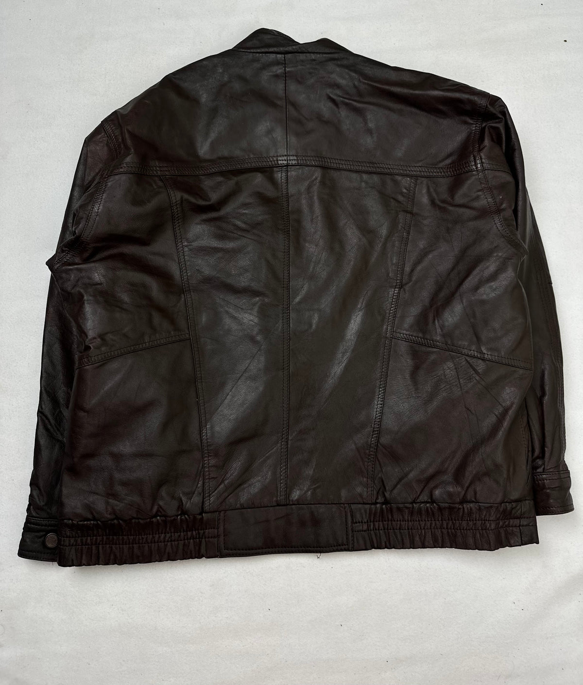 Back of the size XL brown leather flight jacket, laid flat
