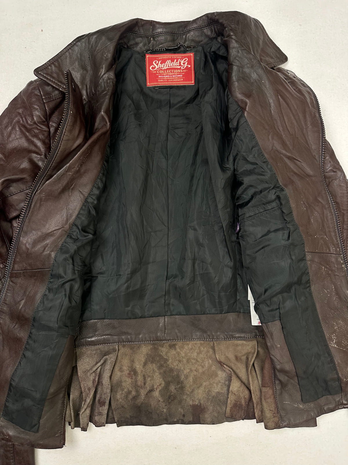 The size XS burgundy leather biker jacket opened to show the lining