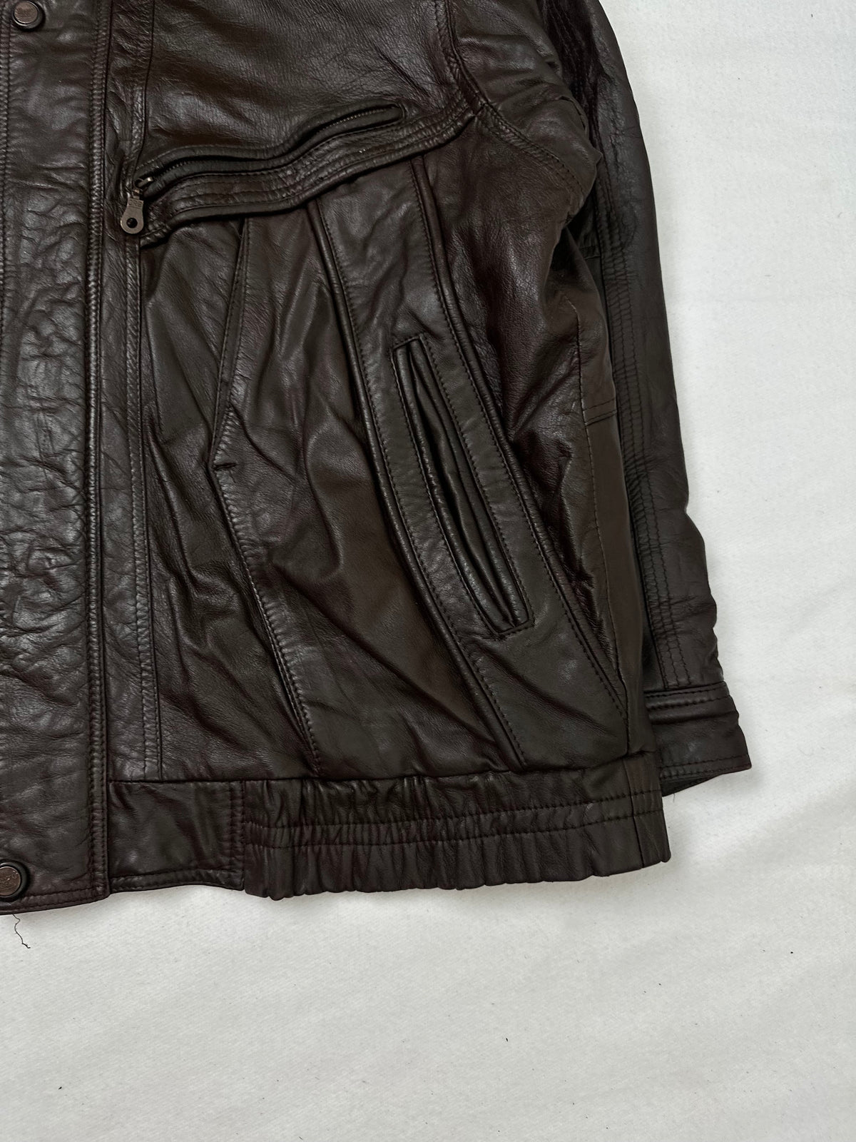 Side pocket and hem of the size XL brown leather flight jacket, up close
