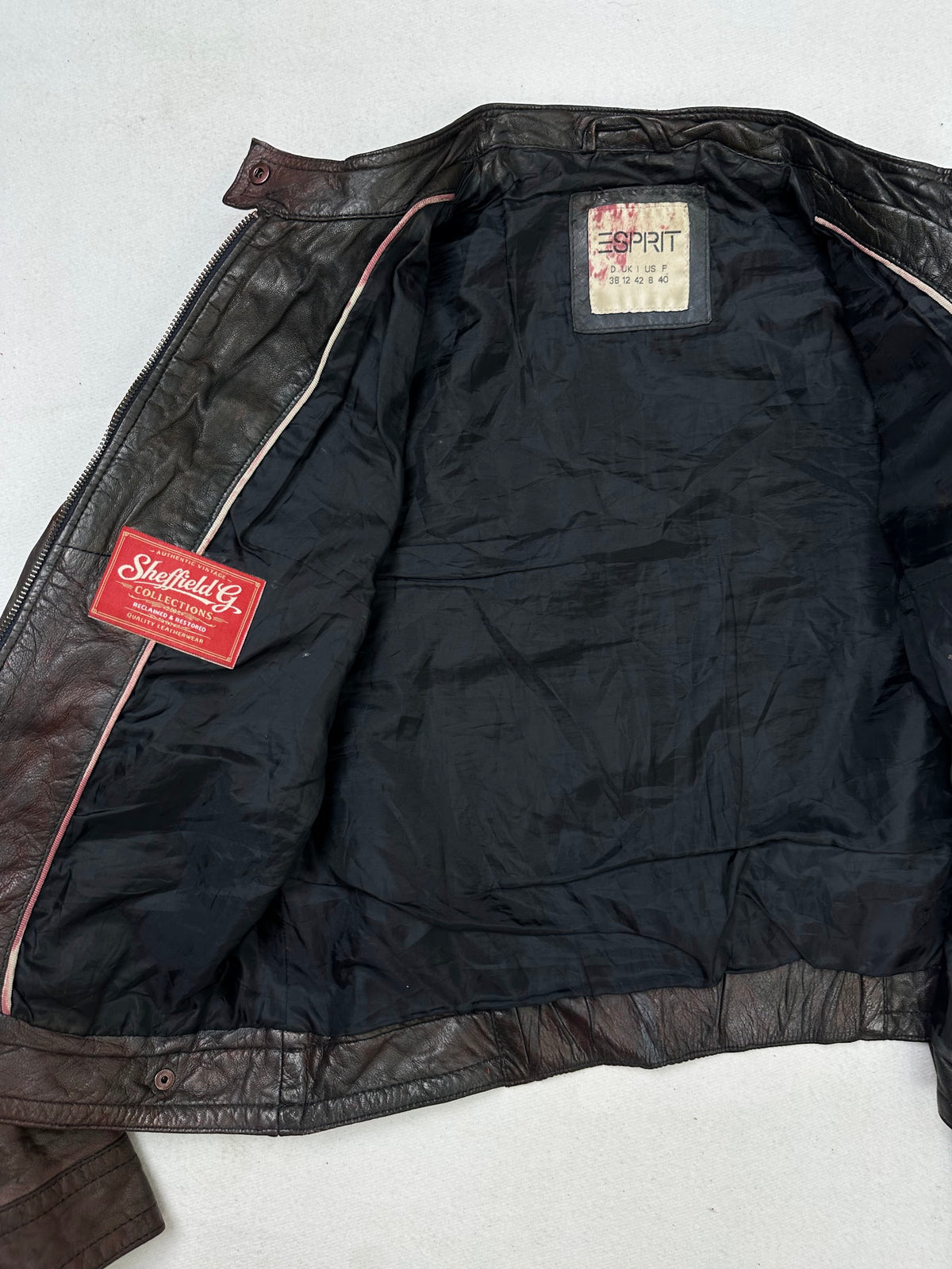 The size S burgundy leather cafe racer jacket opened to show the lining