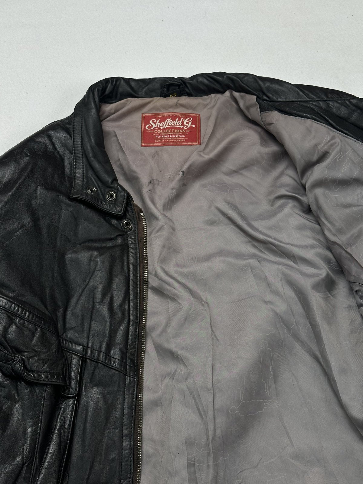 Grey lining and inner collar seen close beside the front zip