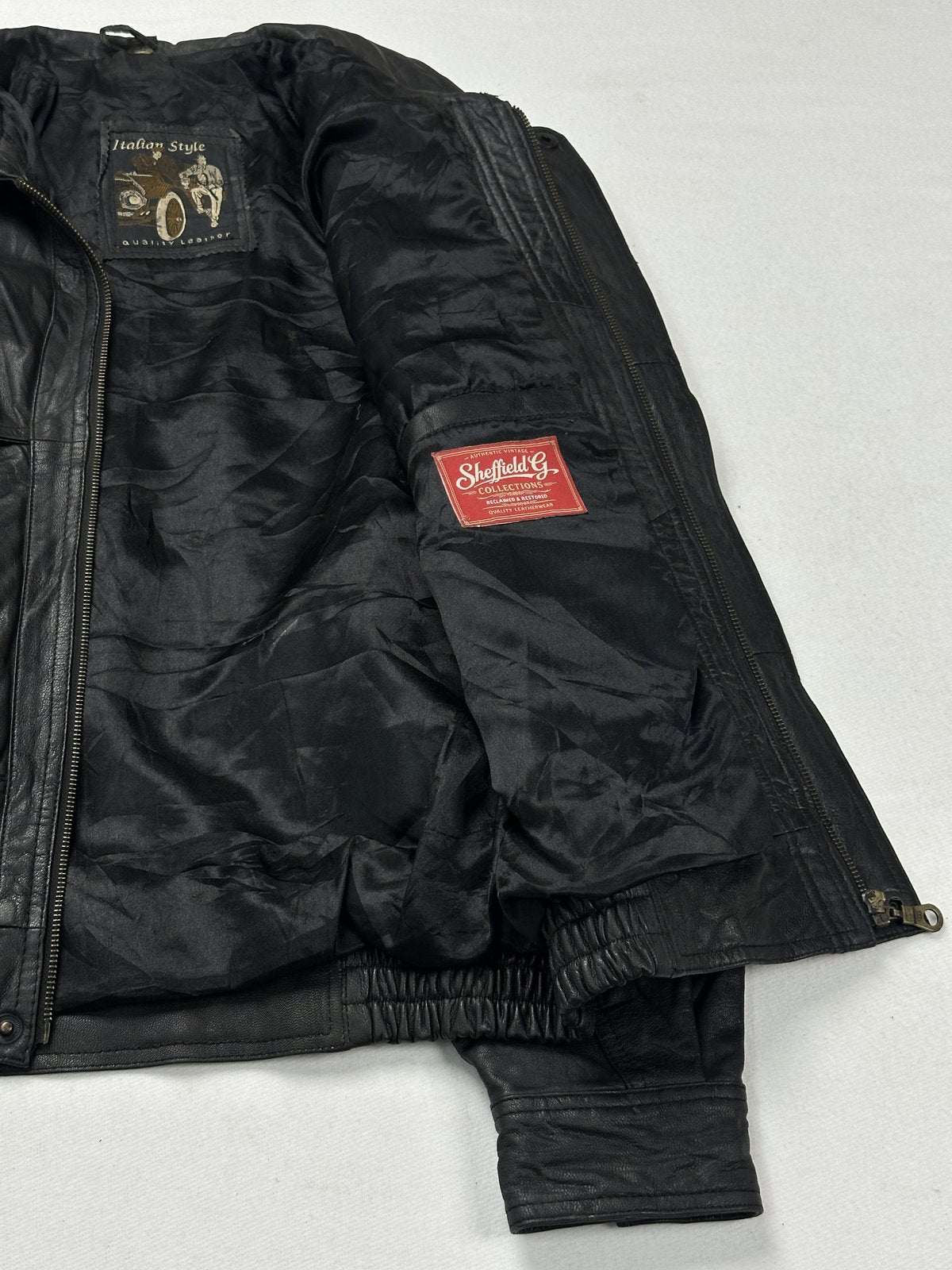 Black leather bomber hybrid with a 25 inch sleeve, size XXL