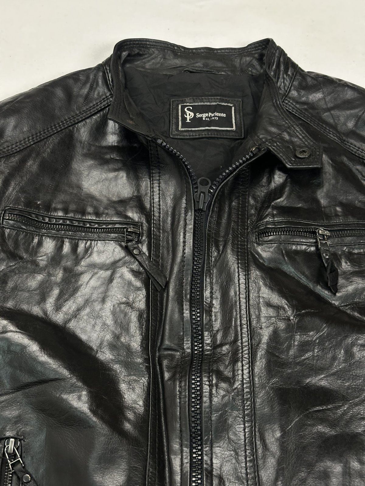 Close view of the band collar and the twin chest zips either side of the main zip