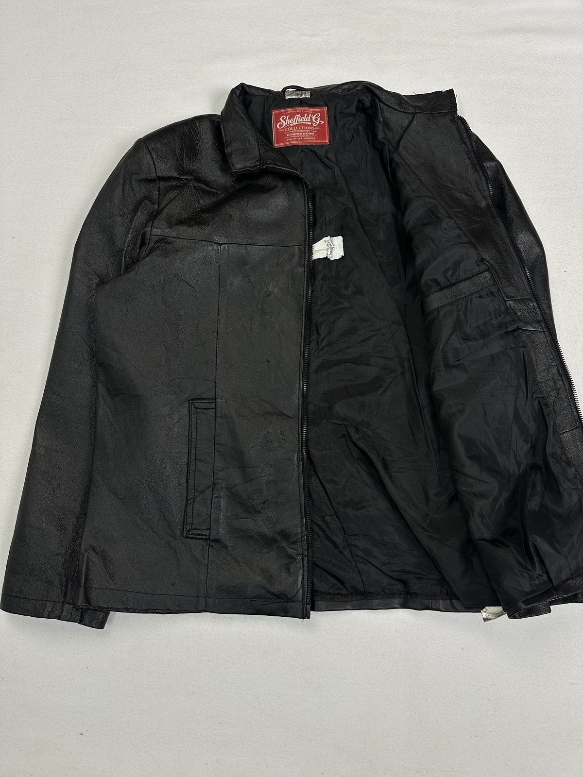 Slim shouldered black leather cafe racer jacket in size L