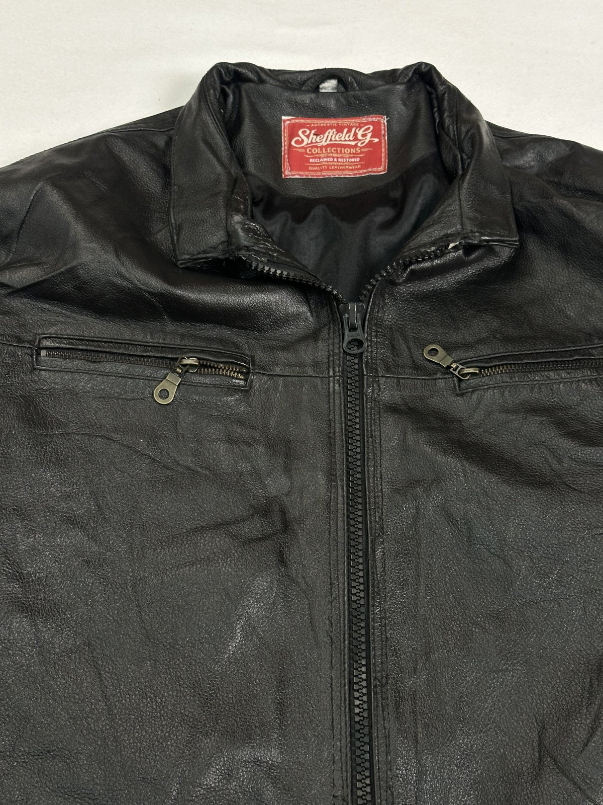 Close view of the stand collar and the twin zipped chest pockets on this vintage jacket