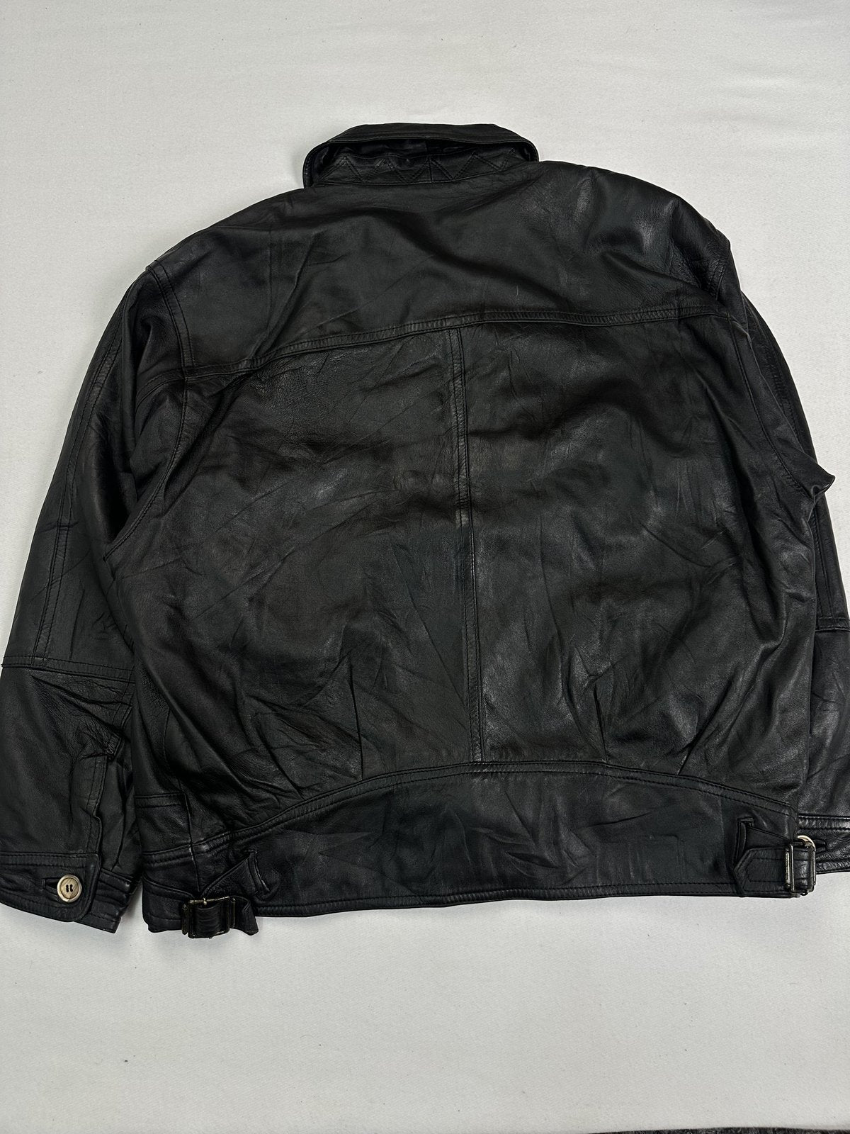 Back of the XXL black cafe racer laid flat showing the buckled tabs at the waistband