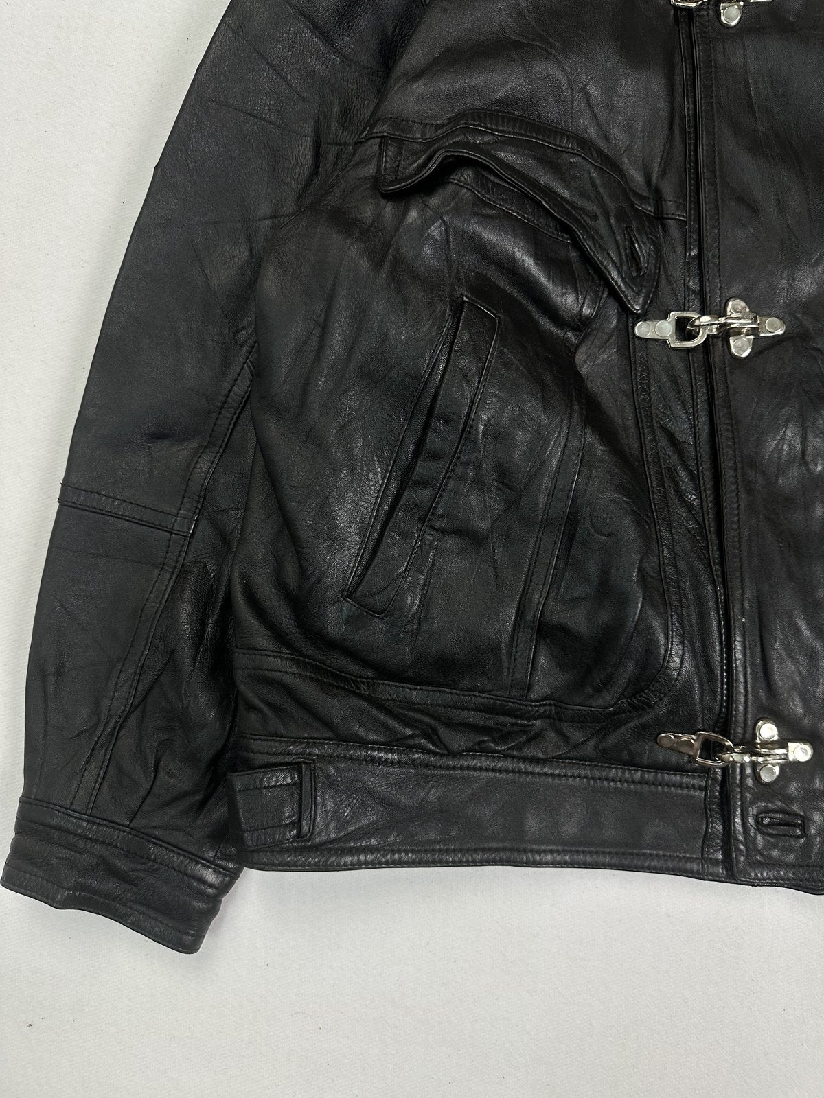 Lower front corner with a slanted hand pocket, the cuff and the leather waistband