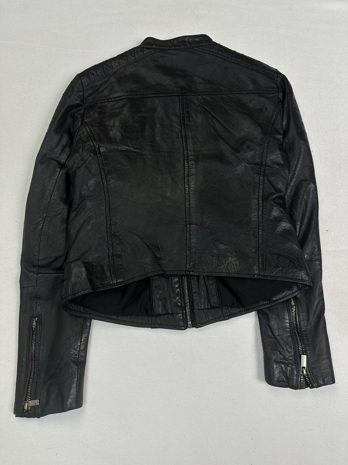 Black leather cafe racer jacket in size S with a compact clean cut