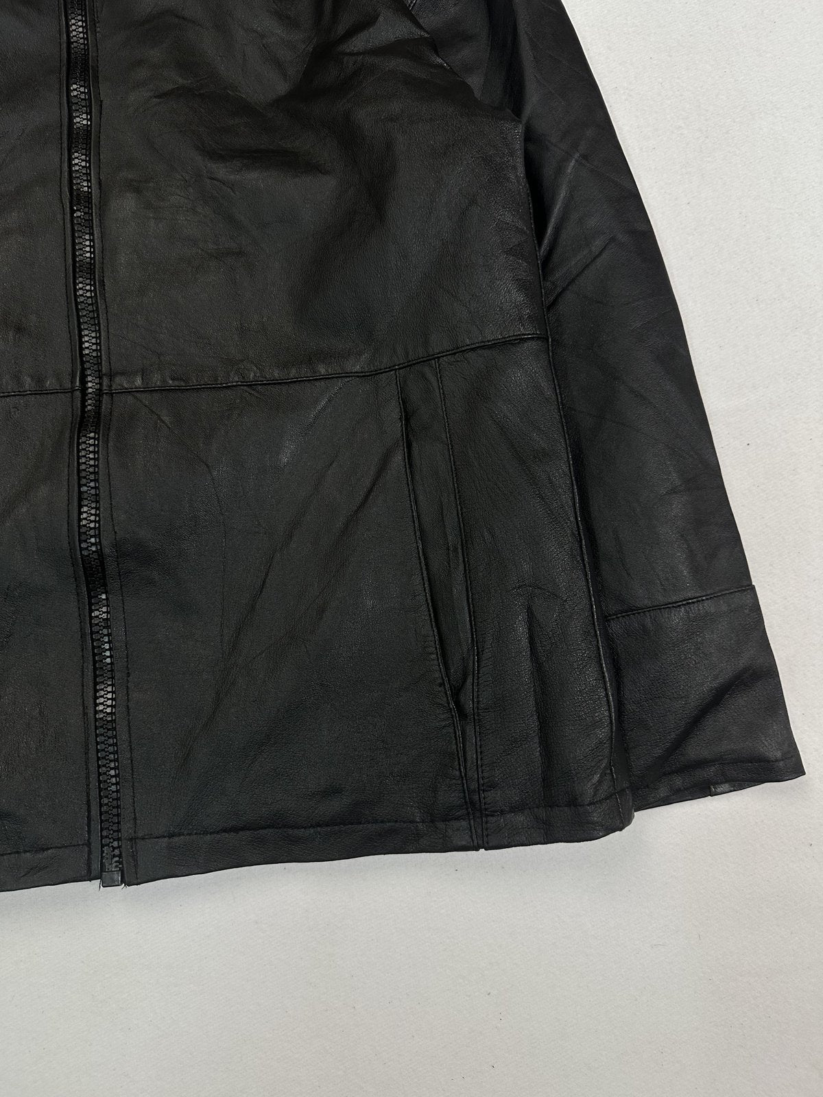 Close view of a slanted hand pocket beside the chunky front zip