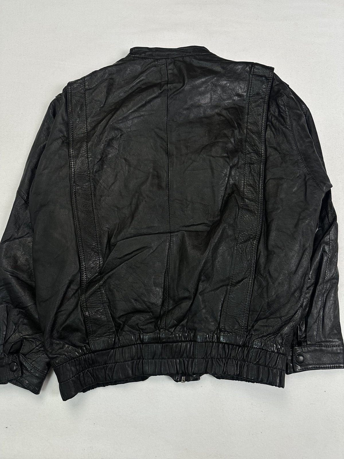 Snap studs running down the placket of the black leather blouson
