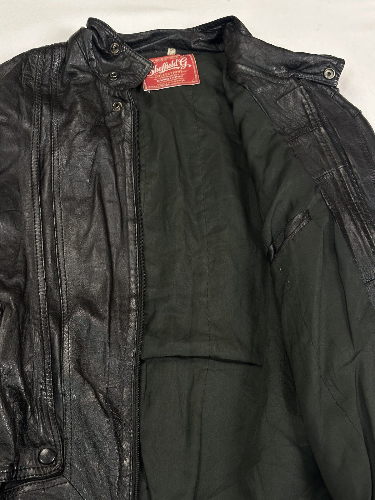 Blouson cut black leather jacket in size XL with a 21 inch shoulder