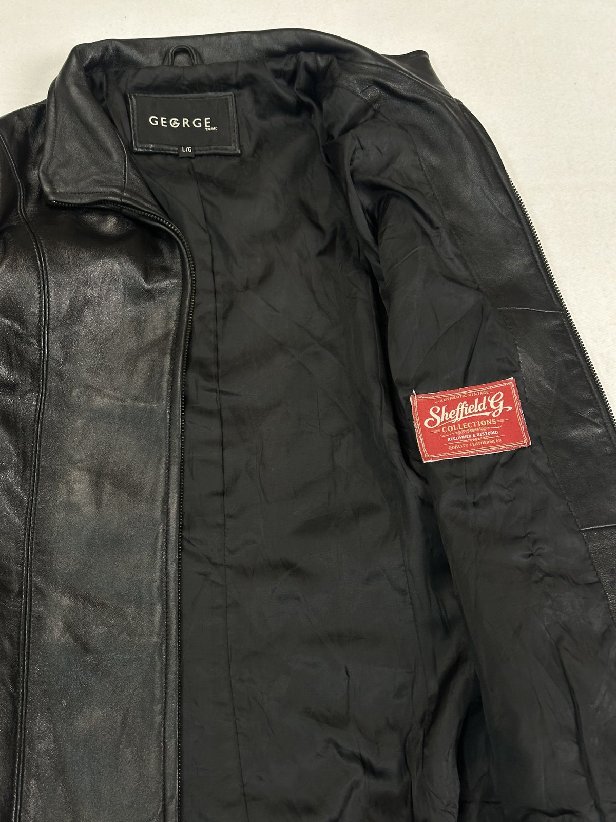 Detail of the red woven label stitched to the lining beside the front zip