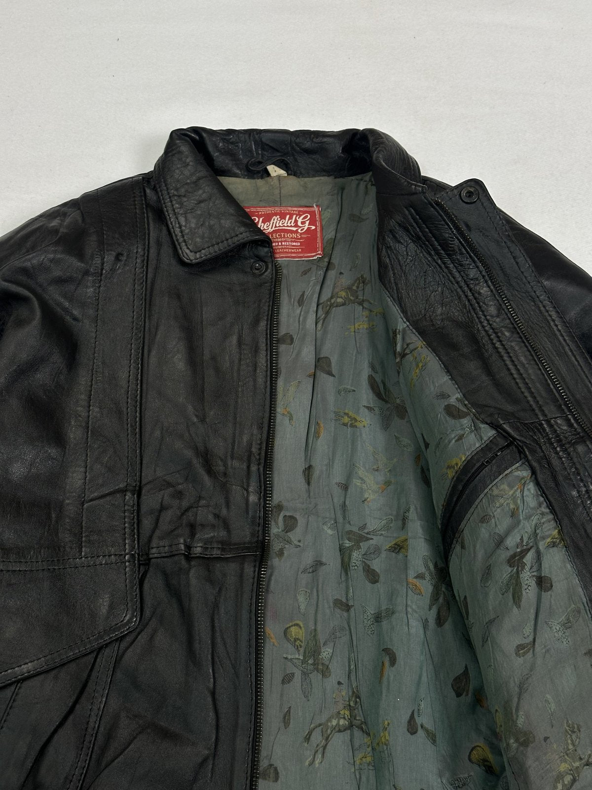 Clean fronted black leather jacket in size XL with the zip hidden away