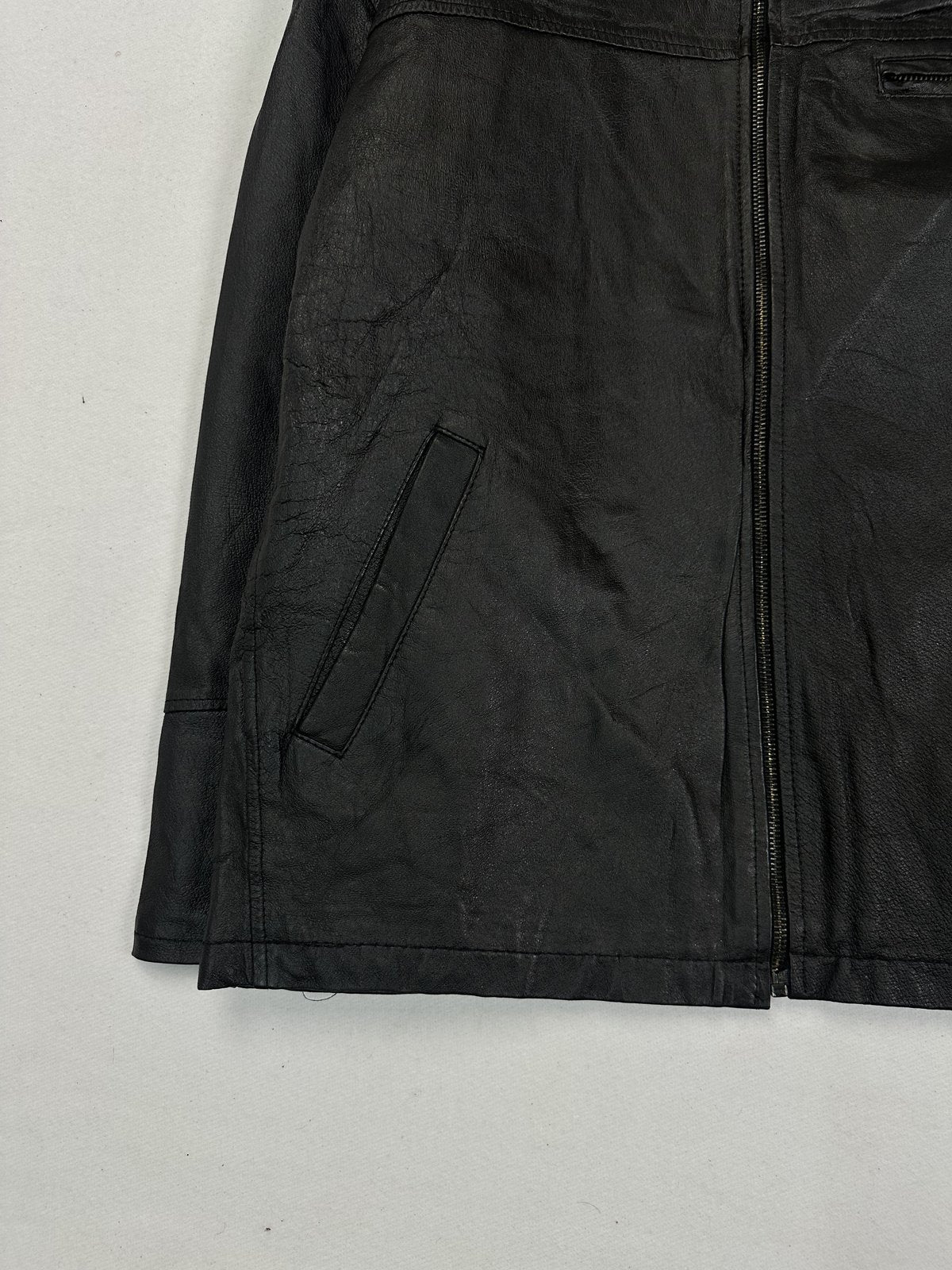 Lower corner of the jacket showing a slanted hand pocket and the straight leather hem
