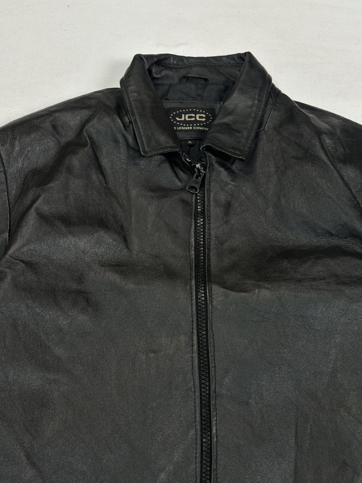 Close view of the shirt collar and the chunky zip pull at the neck of the jacket