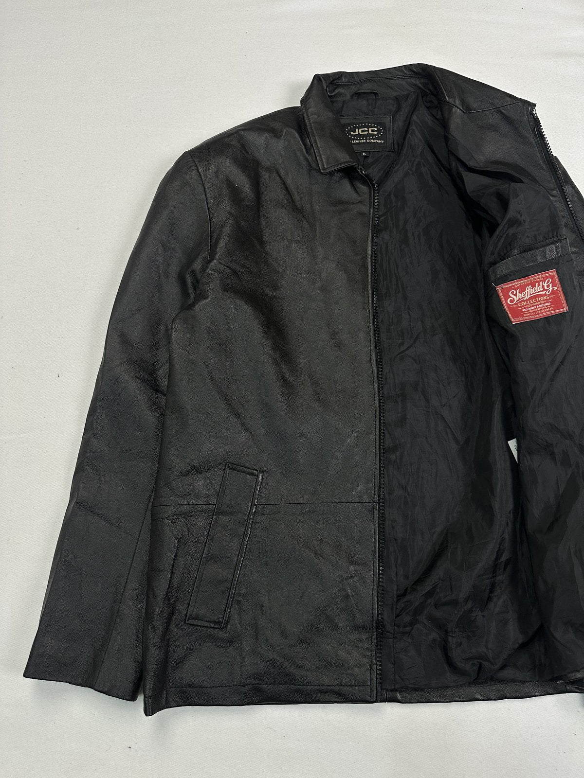 Vintage jacket held open to show the smooth dark lining down the front