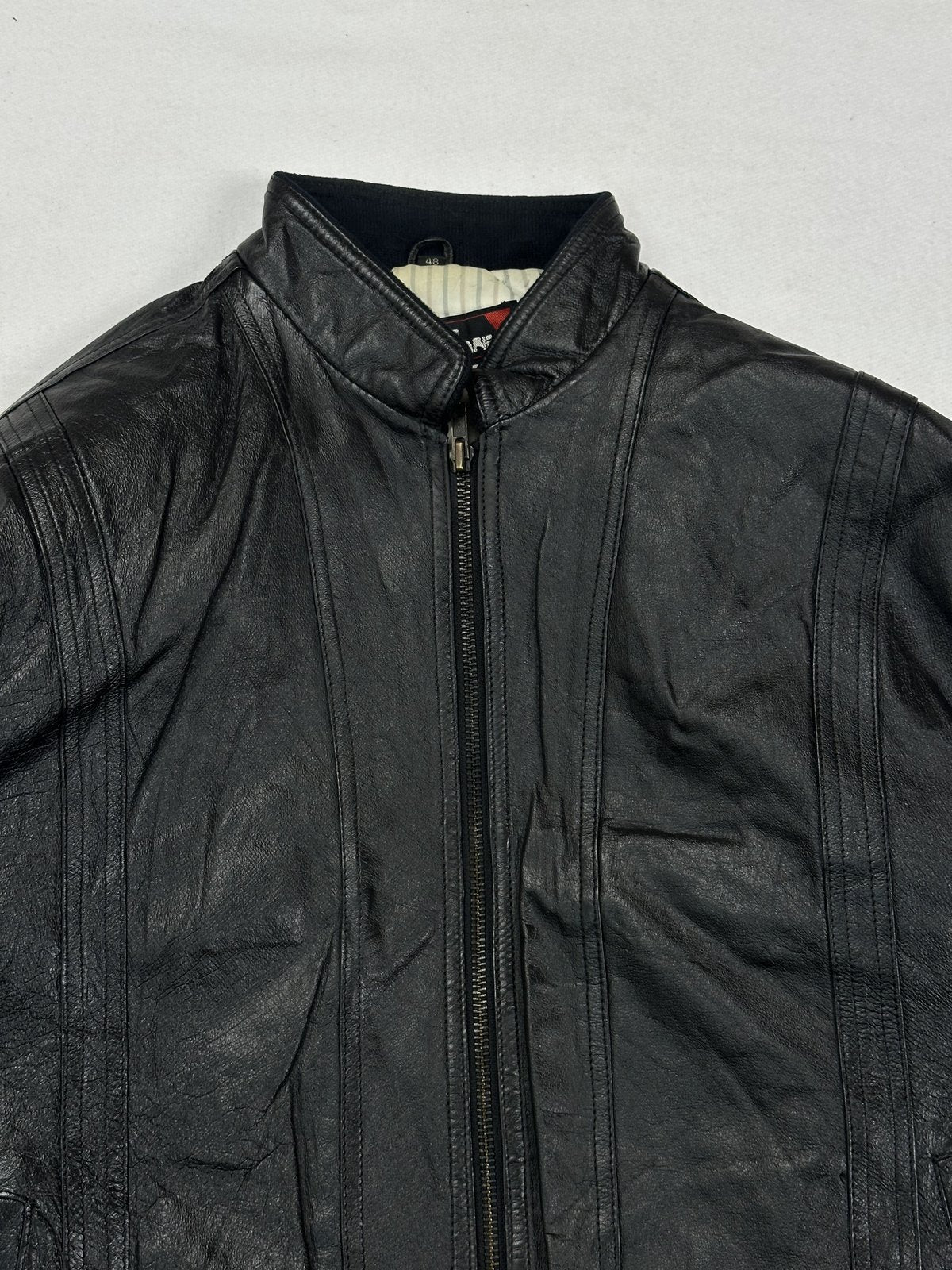 Upper front showing the knit band collar and the panel seams across the chest