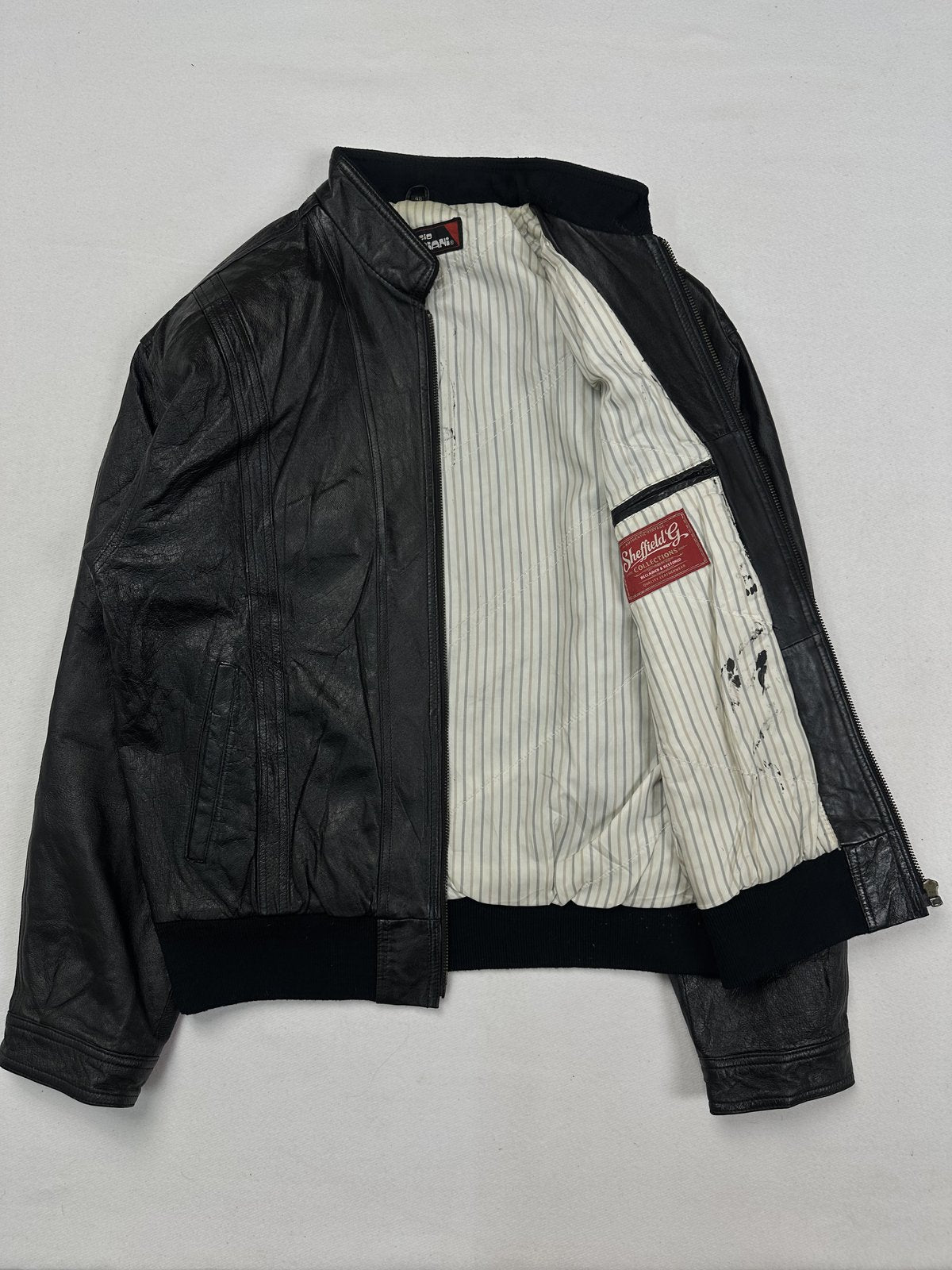 Angled view of the jacket opened right out over its striped lining