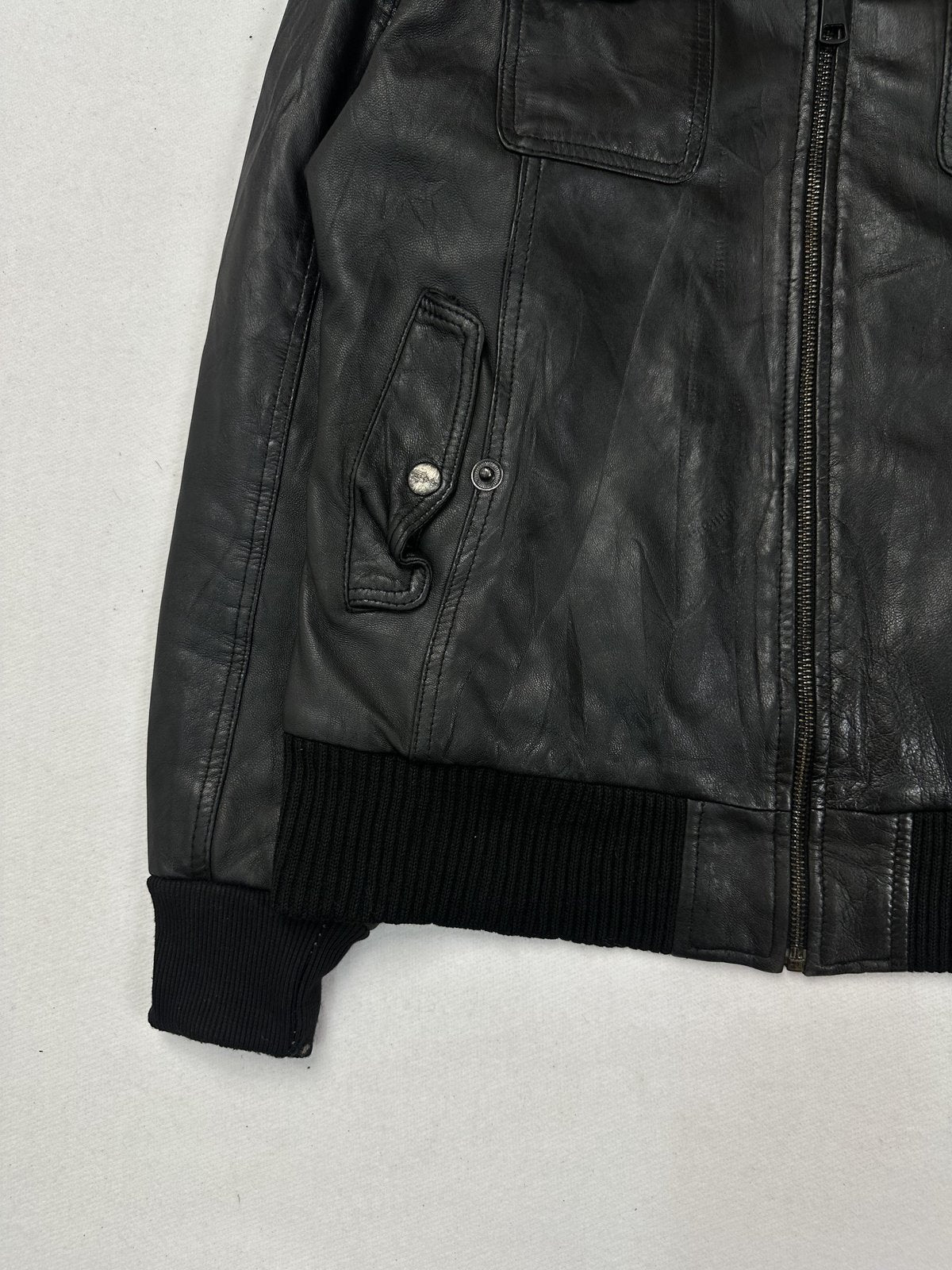 Snap tab fastenings and a full length zip on the black leather bomber