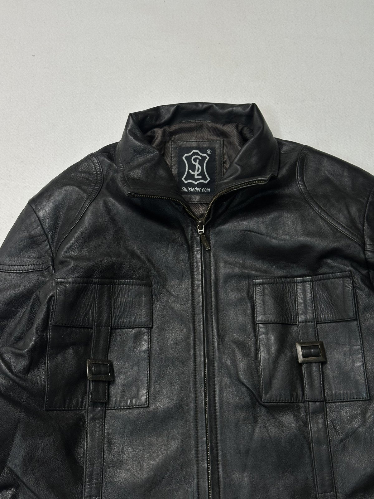 Close view of the stand collar and the two buckle tab chest pockets