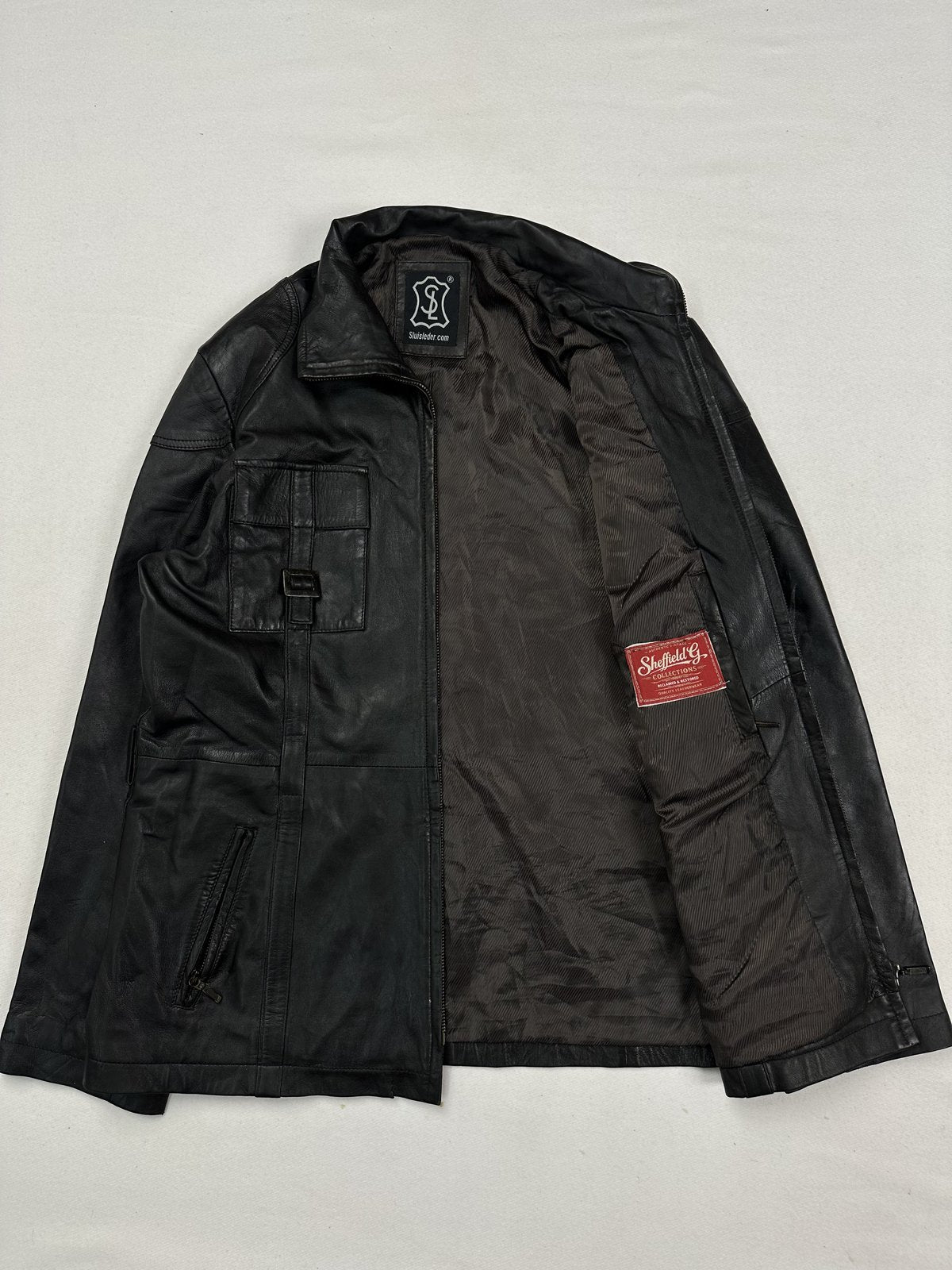Dark lining inside the size L field jacket, held open to show the interior
