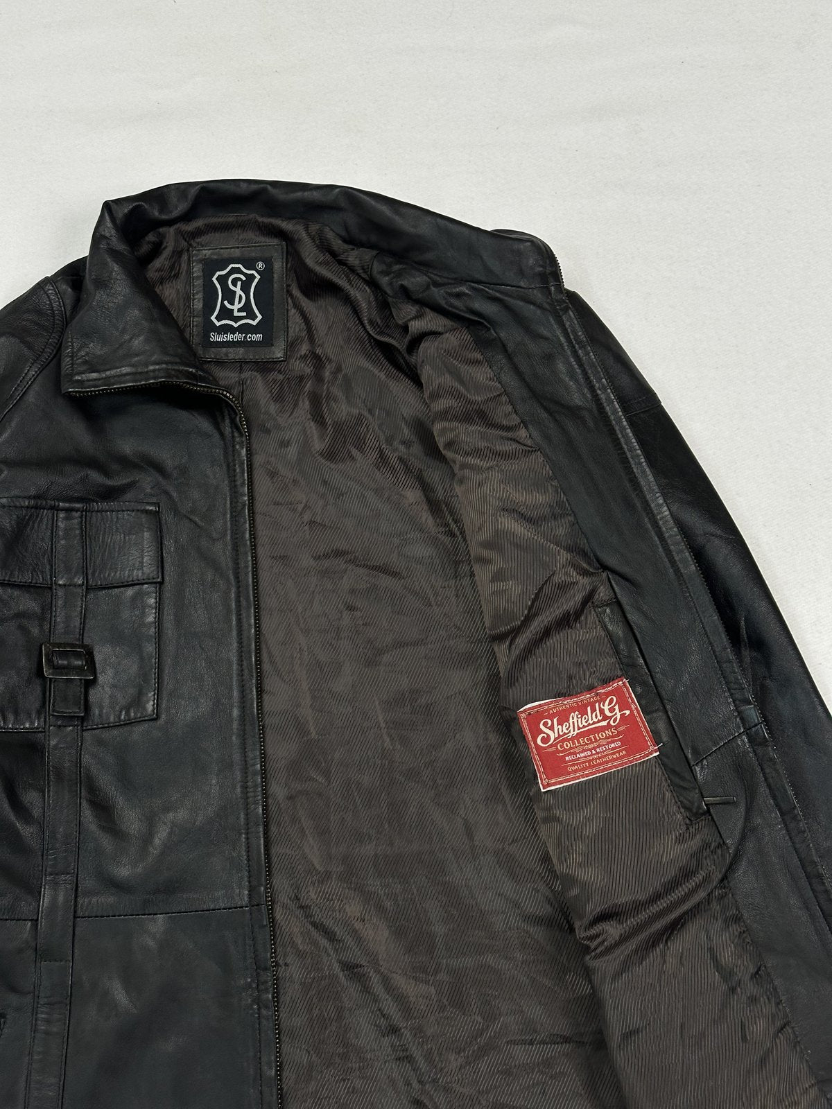 Detail of the red woven label on the lining beside an inner pocket