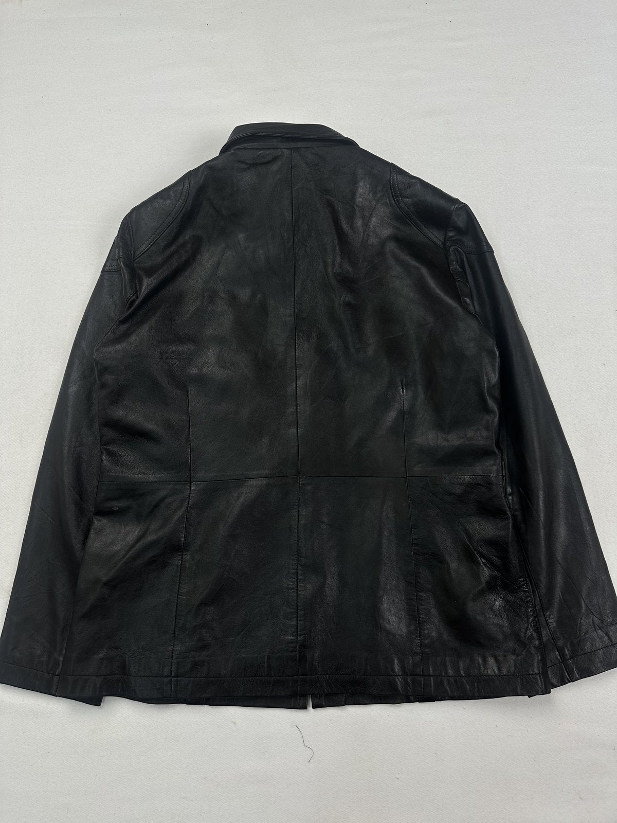 Black leather cafe racer jacket in size L with a yoke seam and clean front