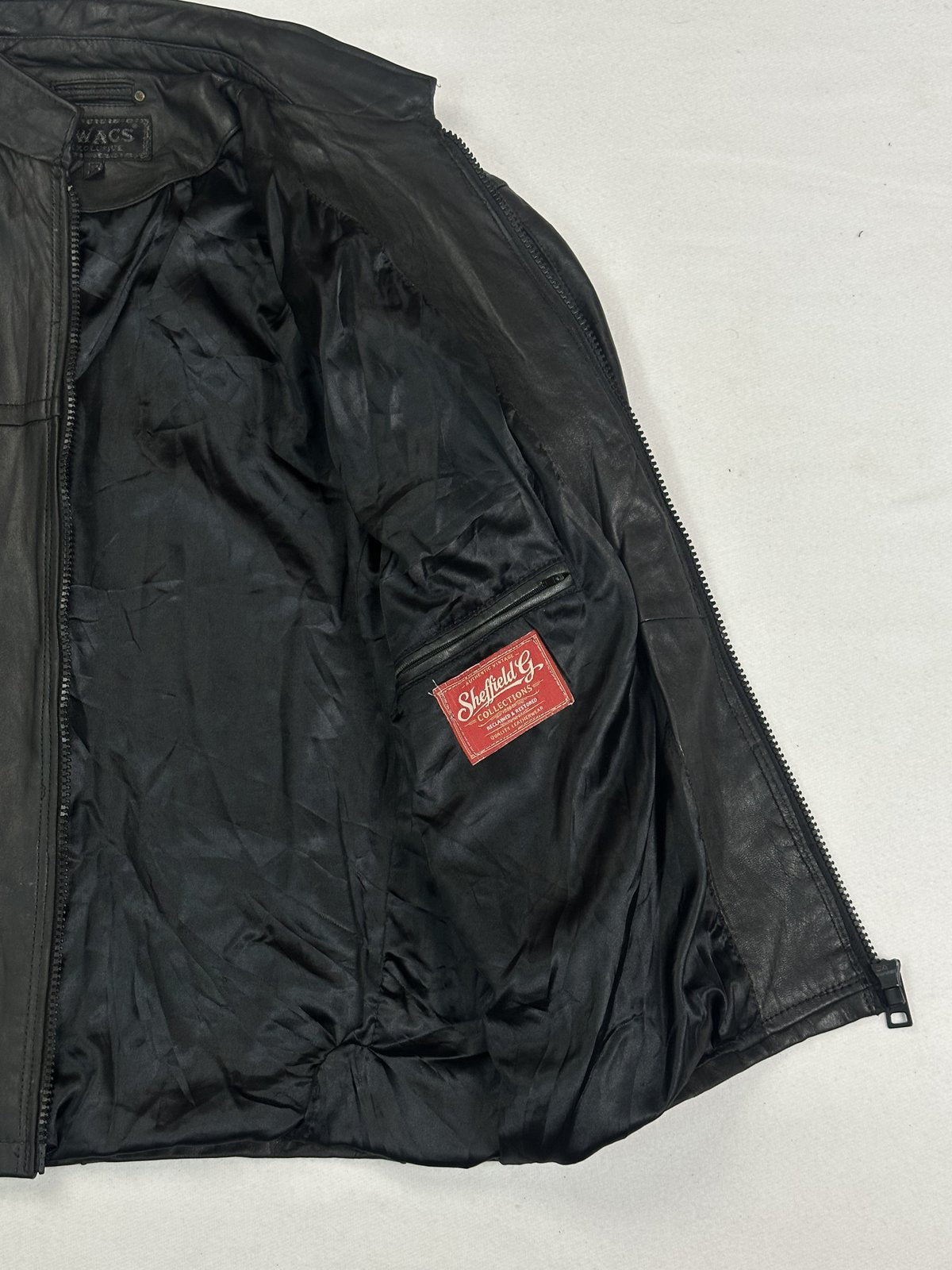 Clean uninterrupted black leather front on this size L jacket