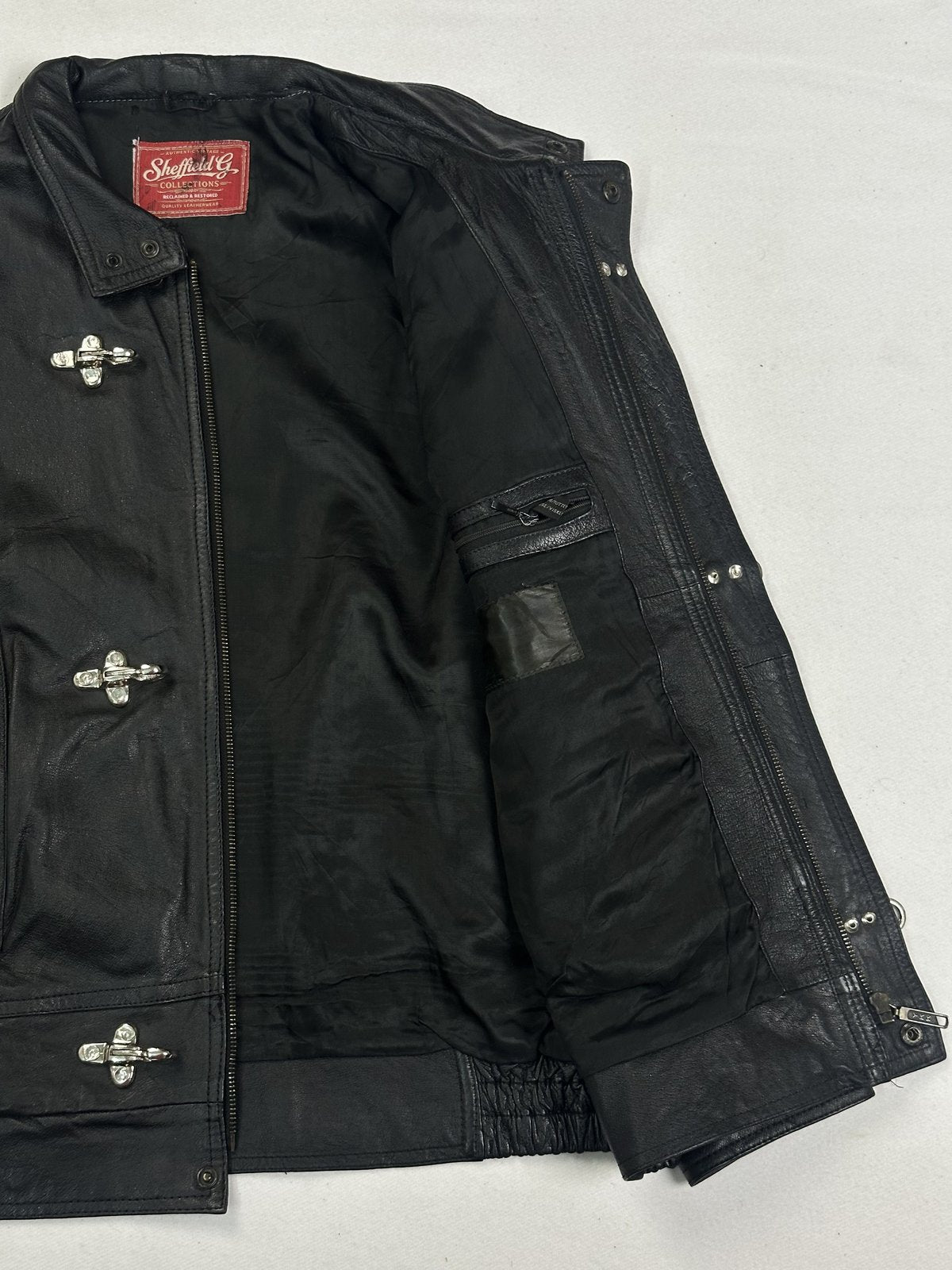 Jacket held open to show the dark lining and the inner pocket at the chest