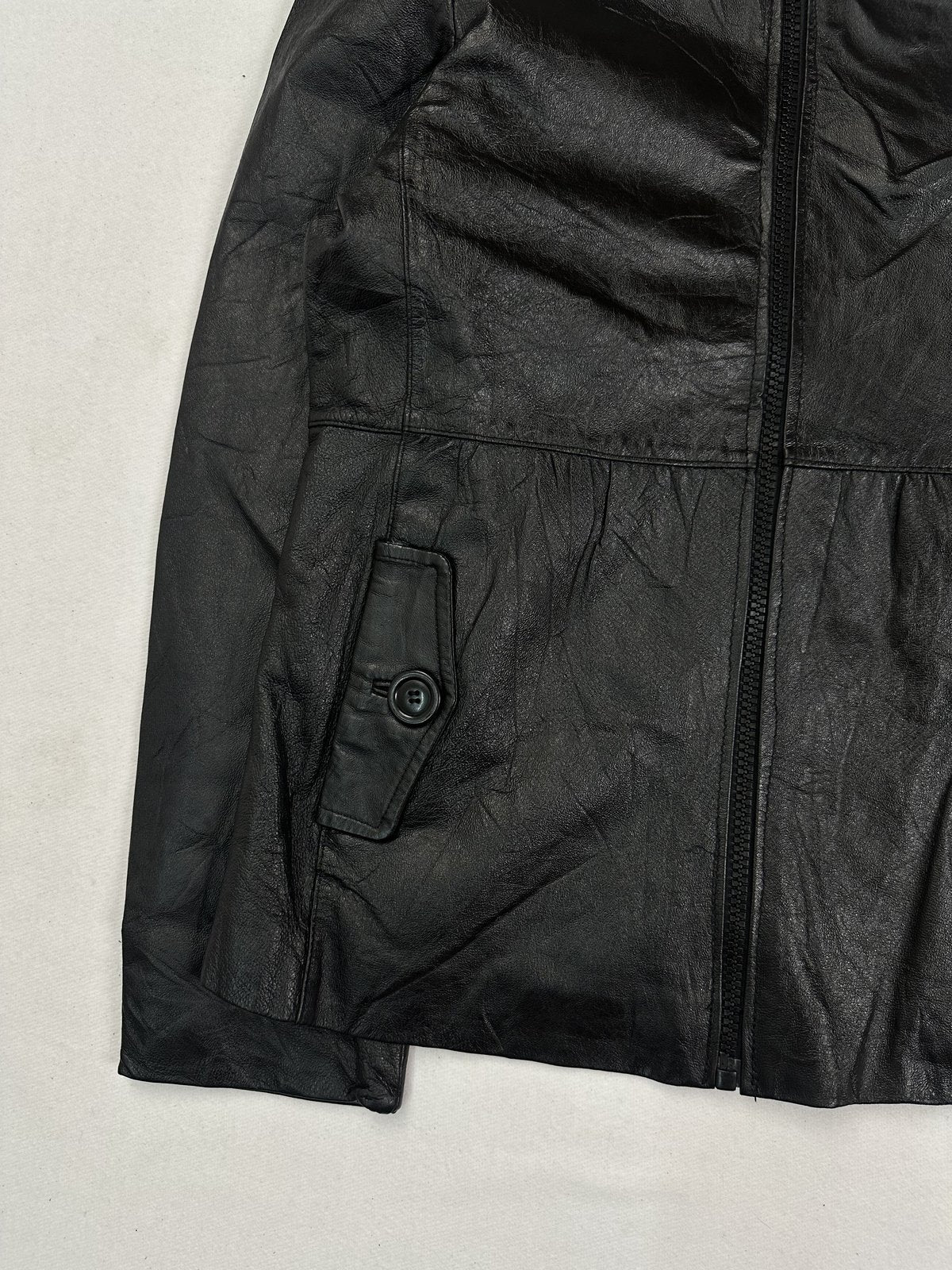 High collar standing at the neck of the black leather jacket